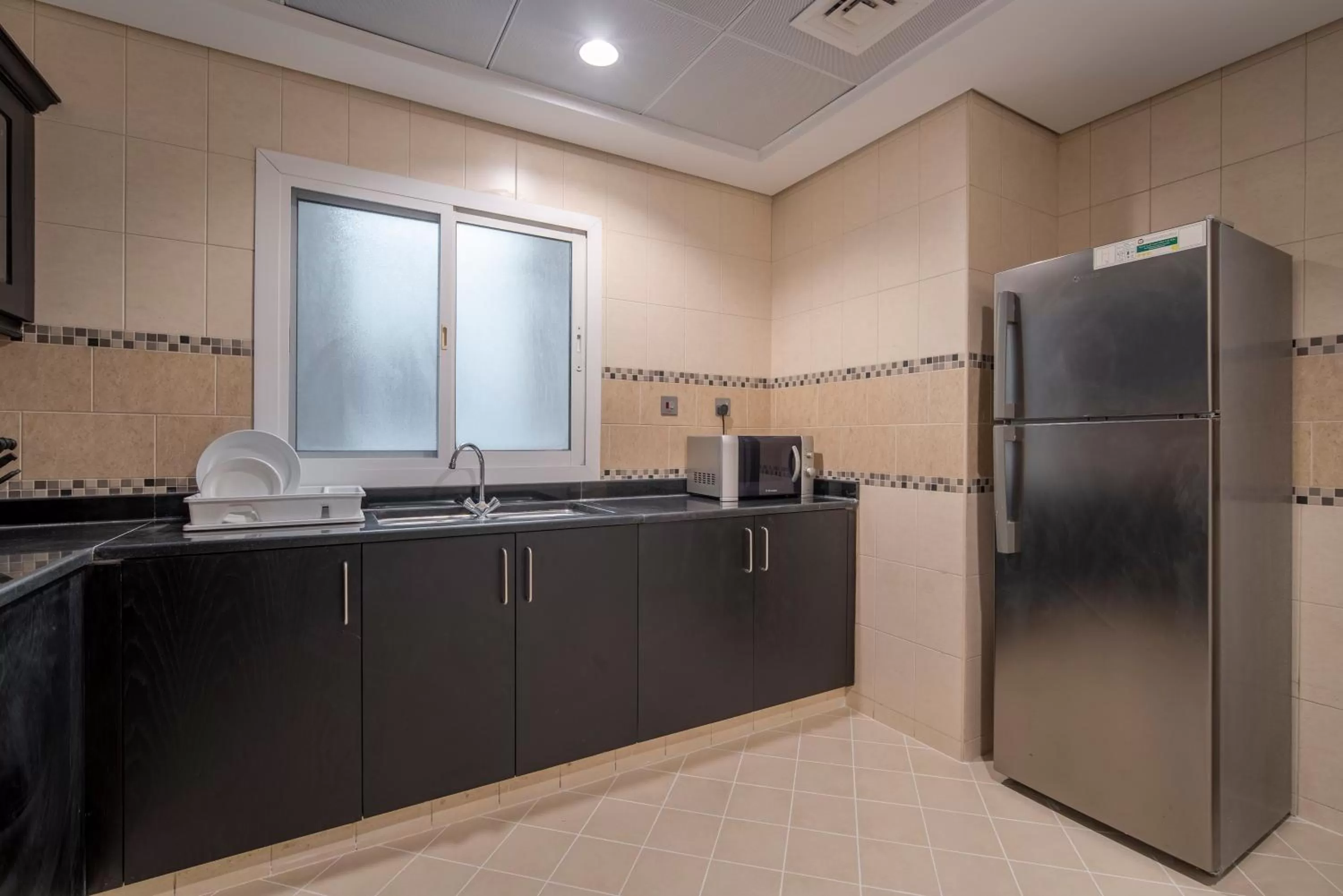 Kitchen or kitchenette in Rose Garden Hotel Apartments - Al Barsha, Near Metro Station
