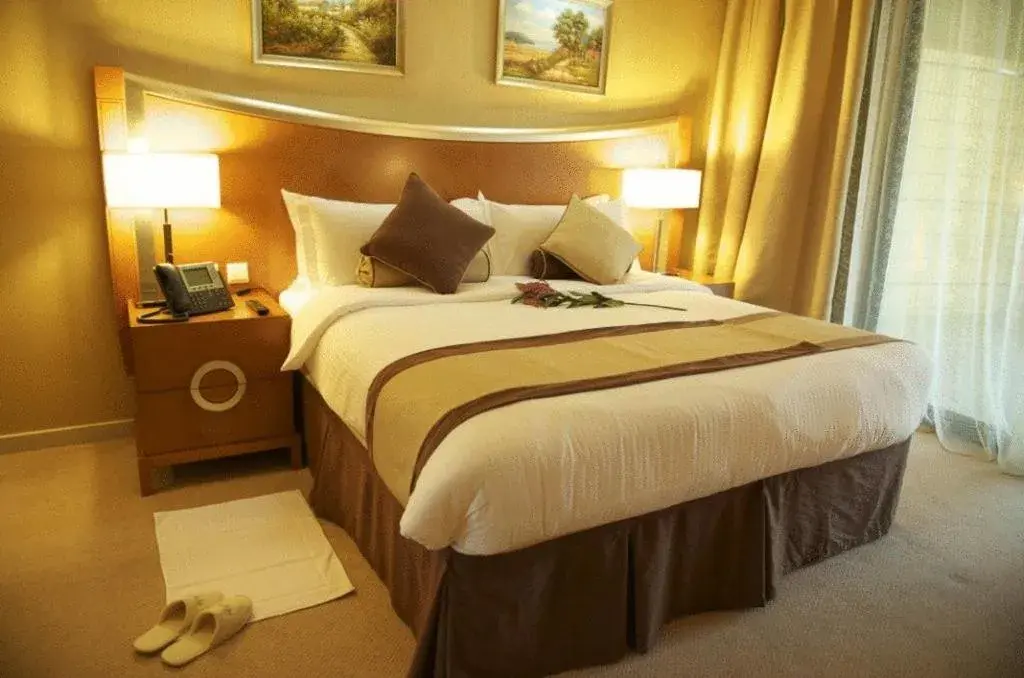 Bed in Grand Bellevue Hotel Apartment Dubai