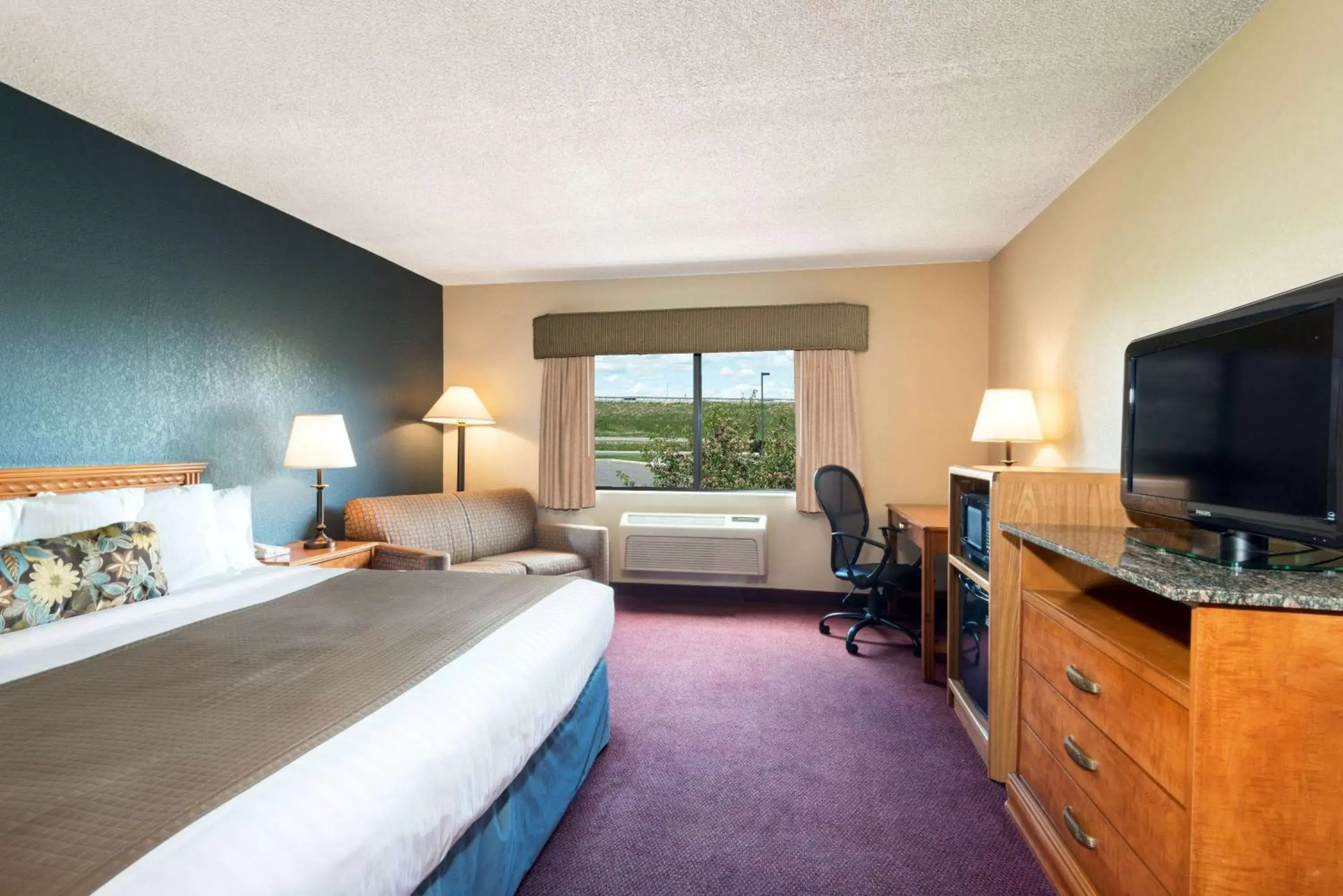 Photo of the whole room, TV/Entertainment Center in AmericInn by Wyndham Rexburg BYUI