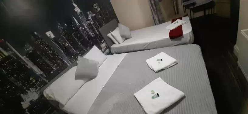 Bed in PRESTIGE PLAZA Hotel