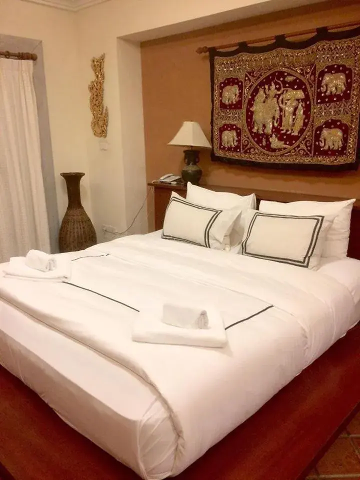 Bed in Nirvana Boutique Suites