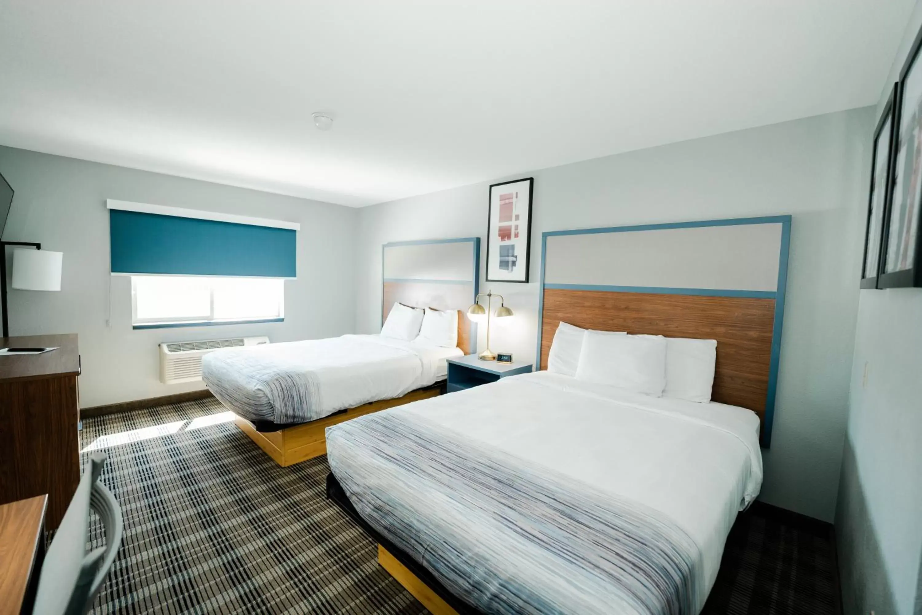 Bed in AmericInn by Wyndham Tomahawk