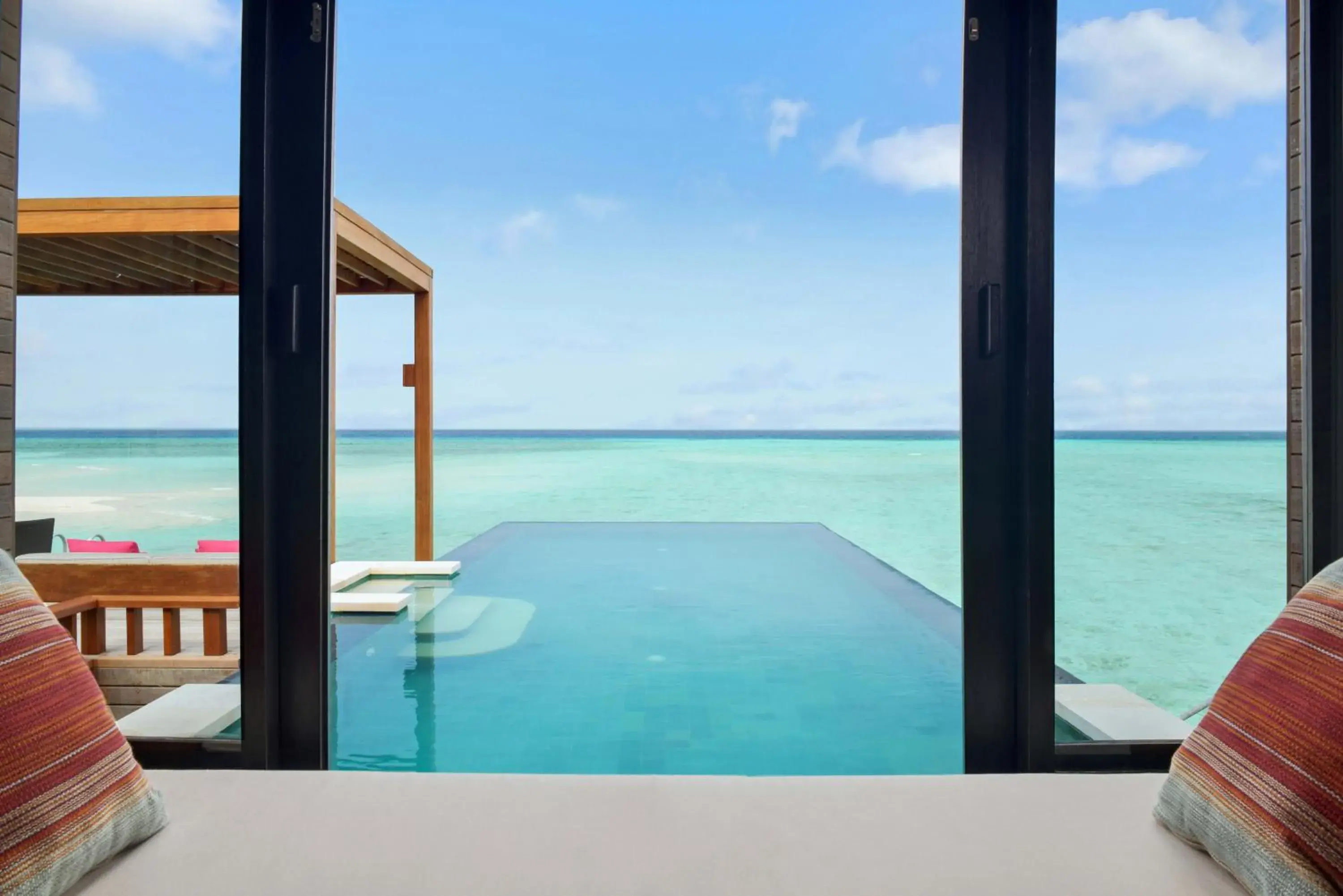 Swimming pool, Balcony/Terrace in Four Seasons Resort Maldives at Kuda Huraa