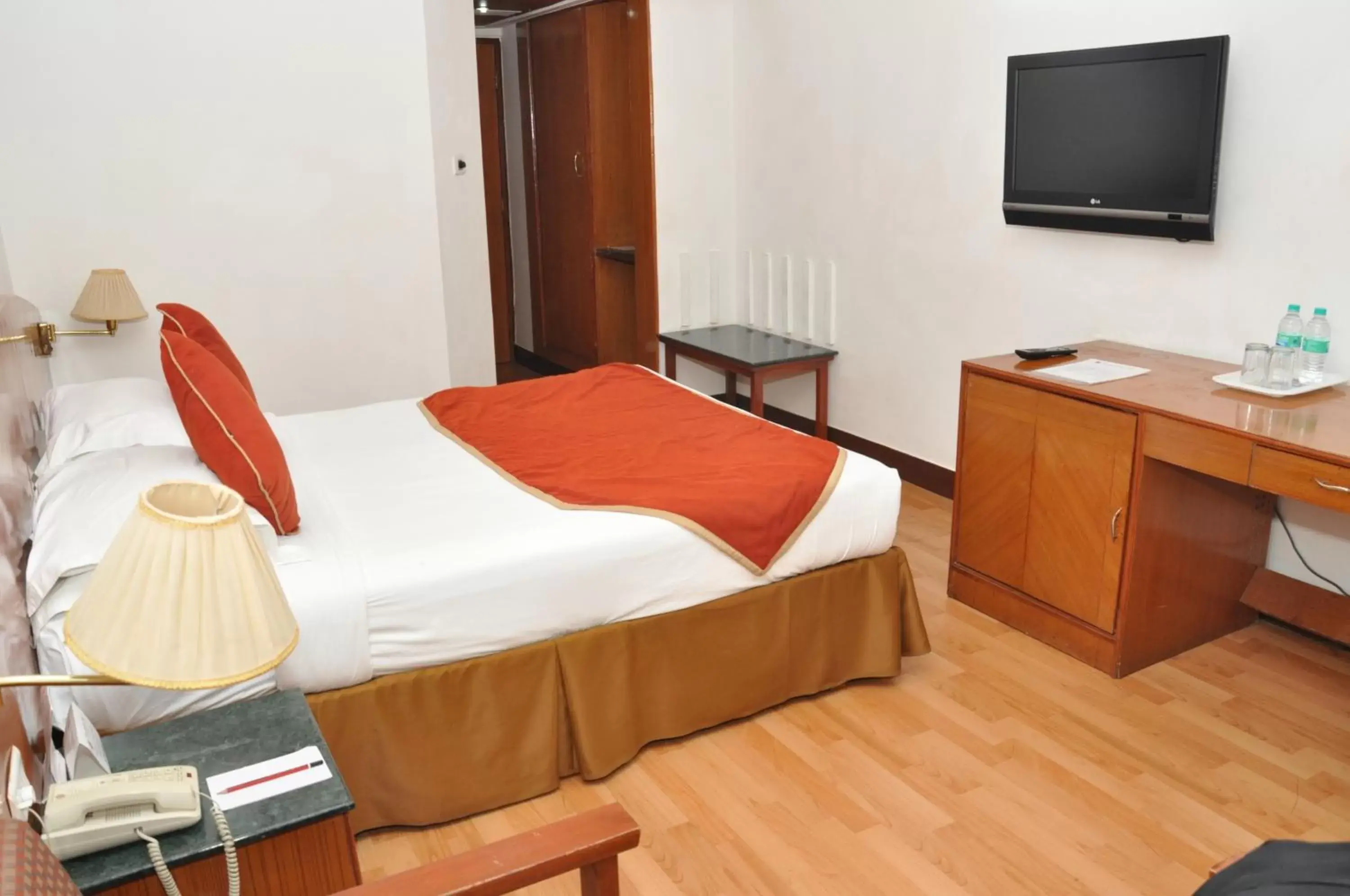 Photo of the whole room, Bed in Ramee Guestline Tirupati