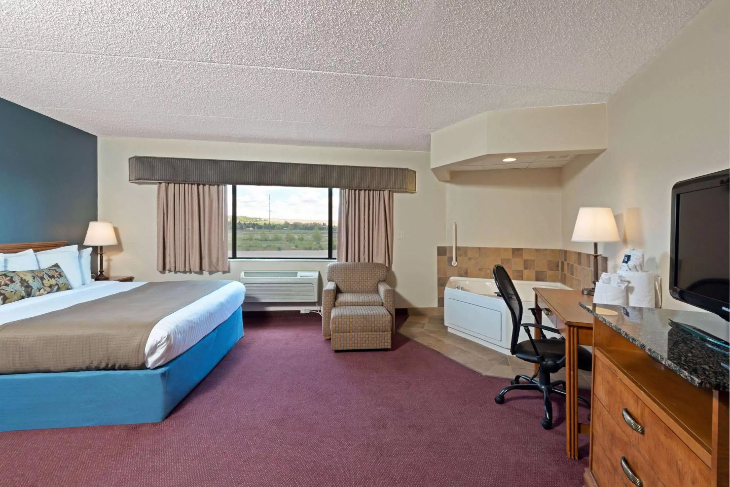 Photo of the whole room, TV/Entertainment Center in AmericInn by Wyndham Rexburg BYUI