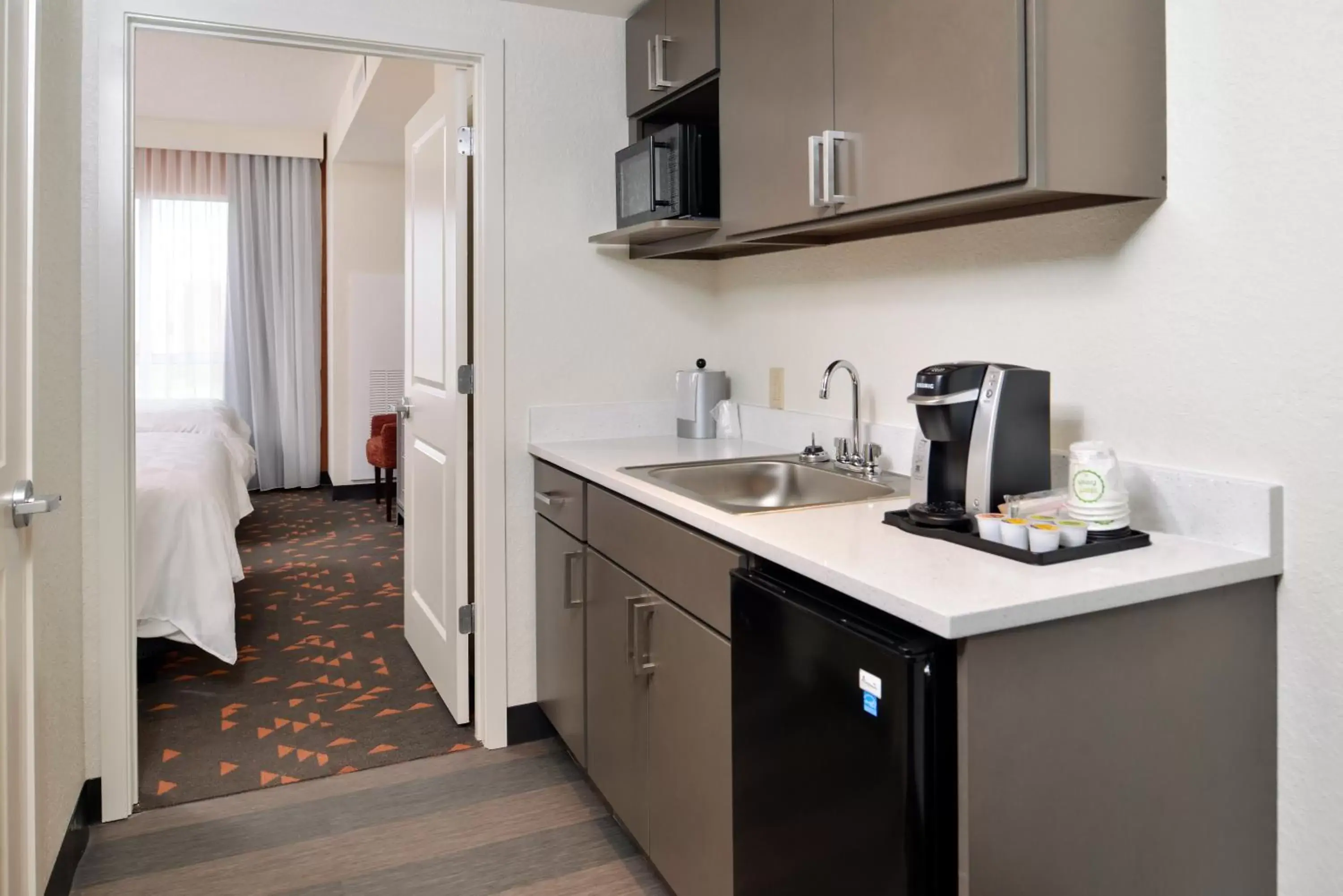 Photo of the whole room, Kitchen/Kitchenette in Holiday Inn & Suites Orlando - International Dr S, an IHG Hotel