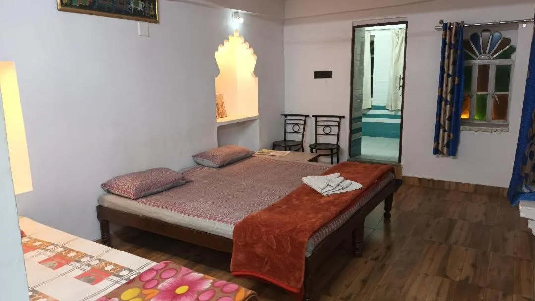 Photo of the whole room, Bed in Jag Niwas Guest House & pure veg restaurant