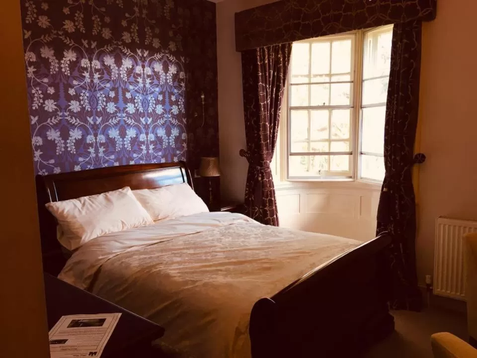 Bed in Brass Castle Country House Accommodation