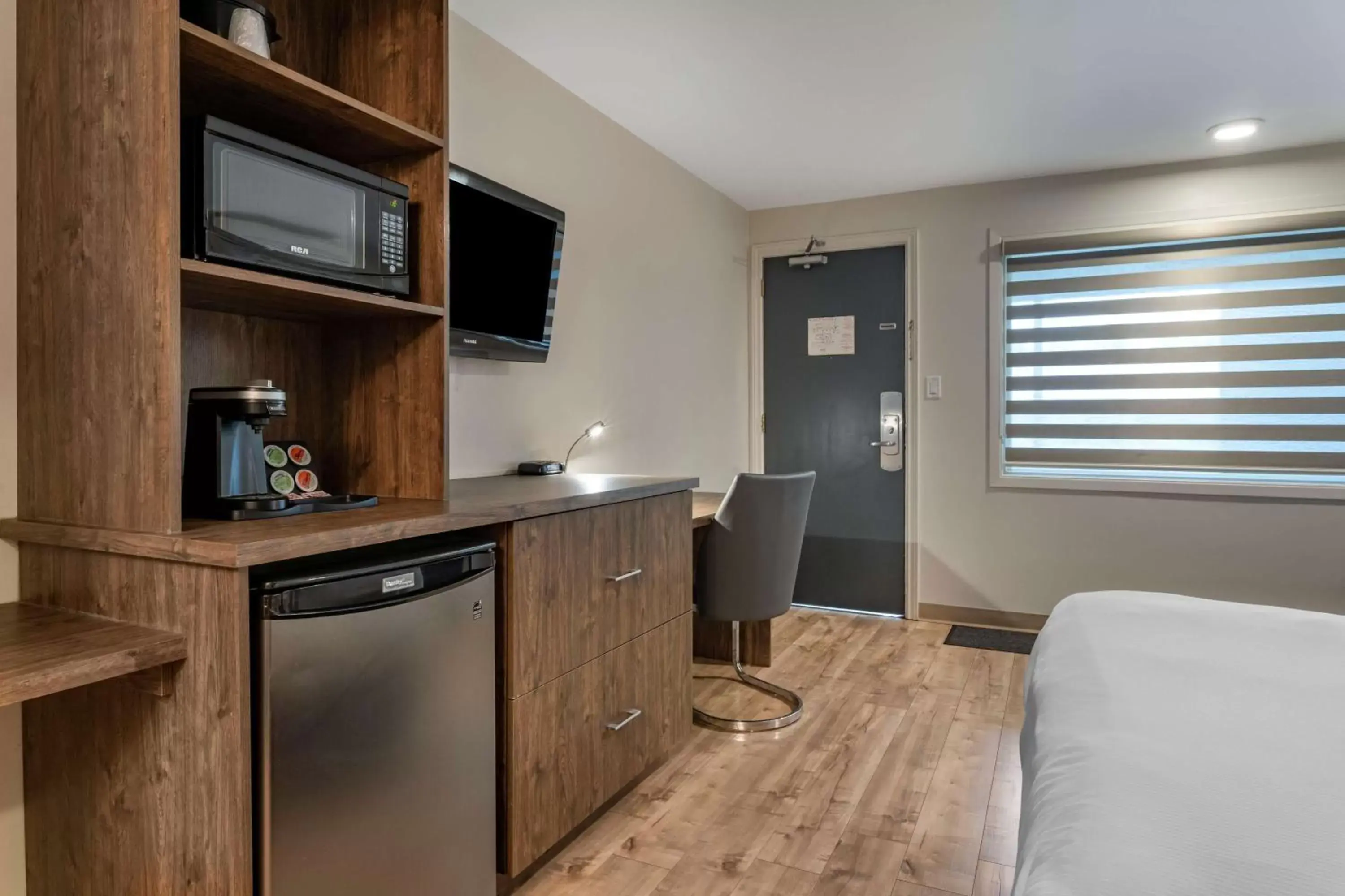 Bedroom, Kitchen/Kitchenette in Dannys Hotel Suites; SureStay Collection by Best Western