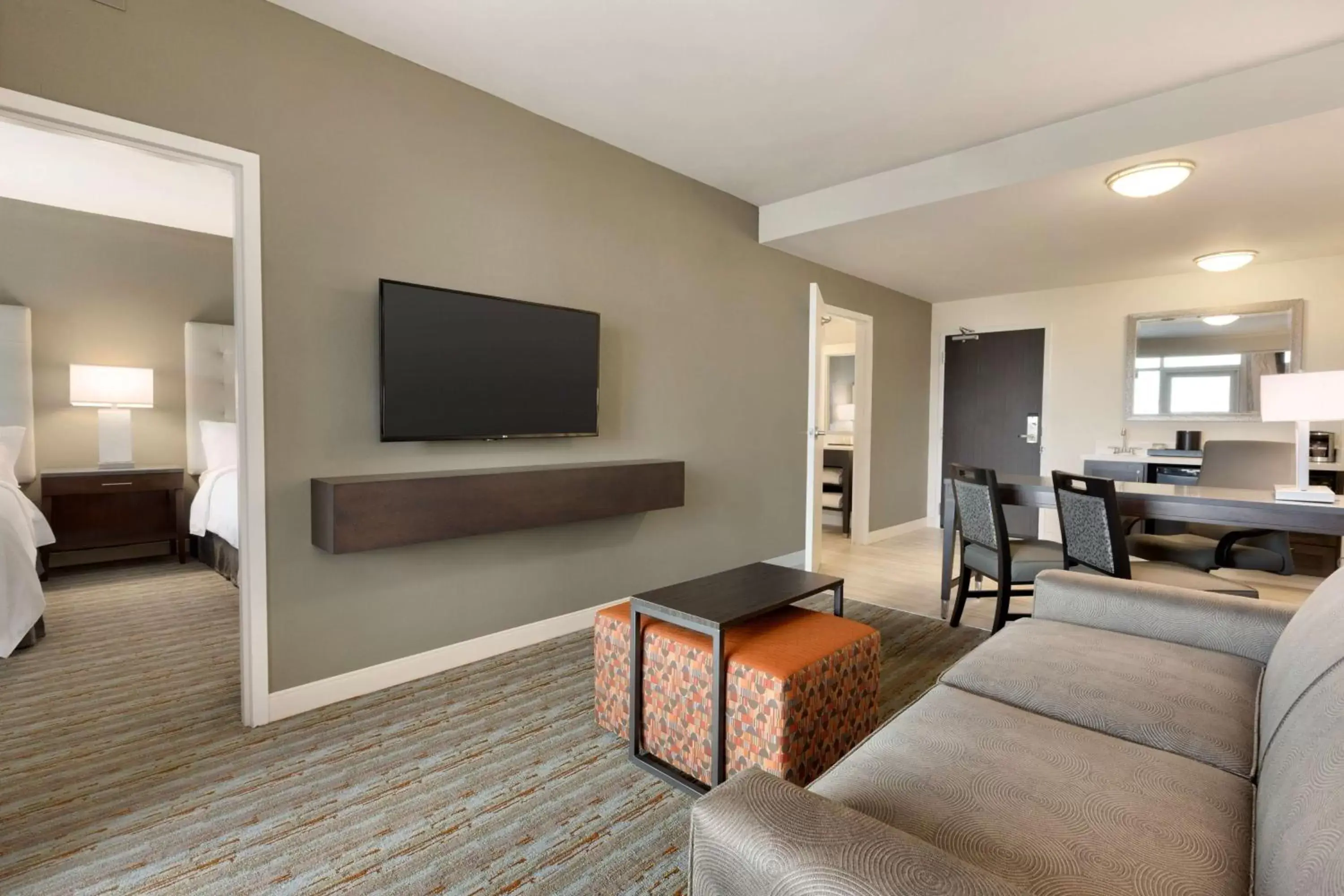 Living room, TV/Entertainment Center in Embassy Suites by Hilton Greenville Downtown Riverplace
