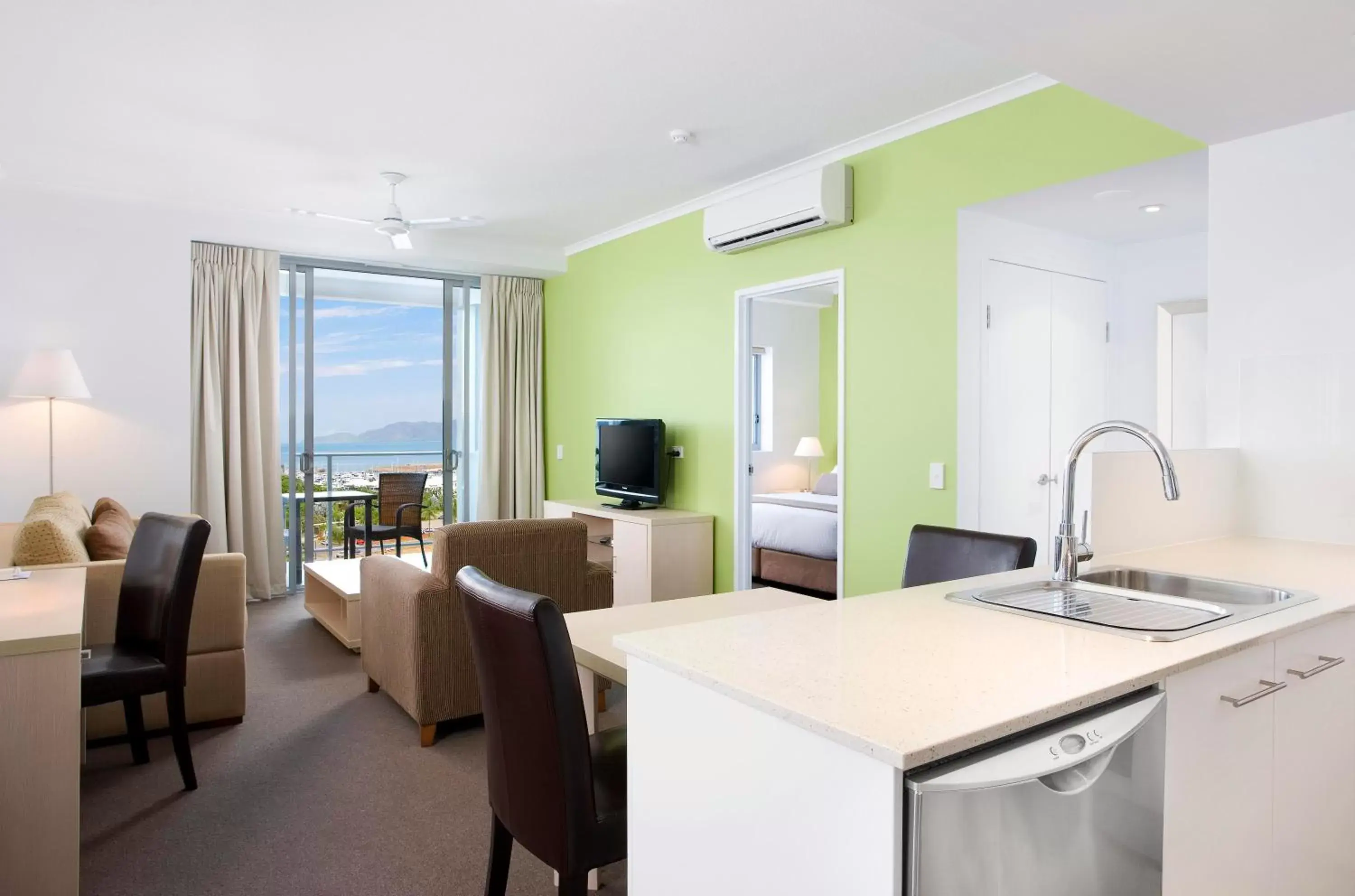 Living room, Kitchen/Kitchenette in Oaks Townsville Gateway Suites