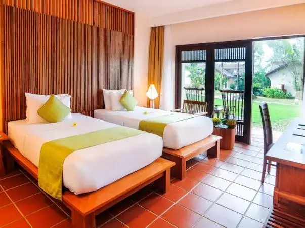 Bed in Palm Garden Beach Resort & Spa