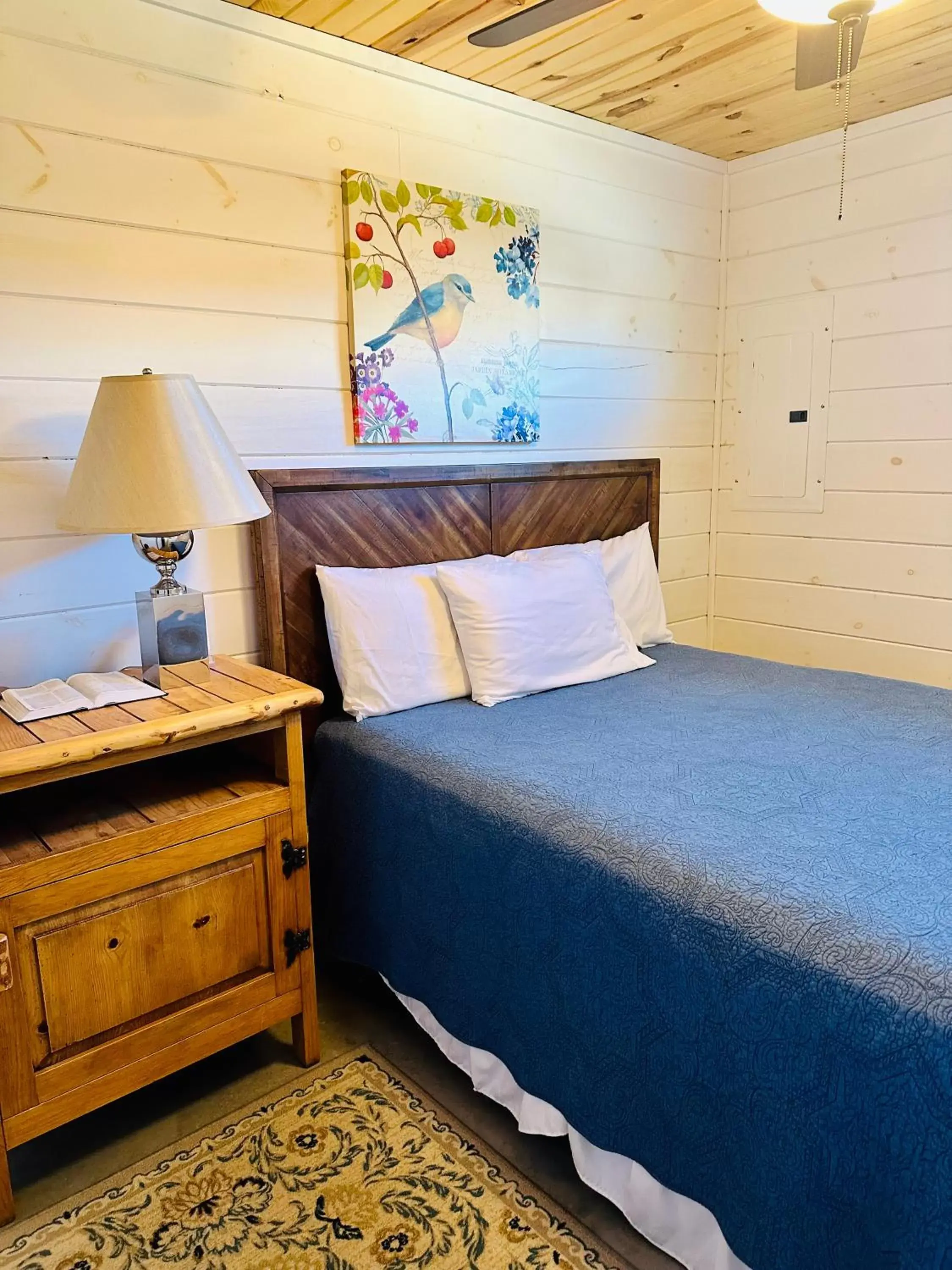 Bed in Knotty Squirrel Cabins