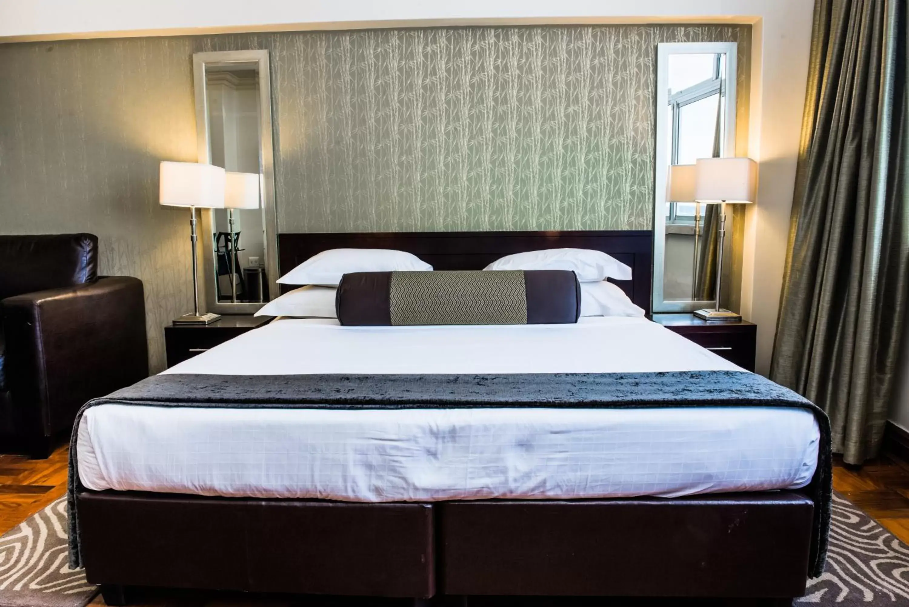 Bed in Belaire Suites Hotel