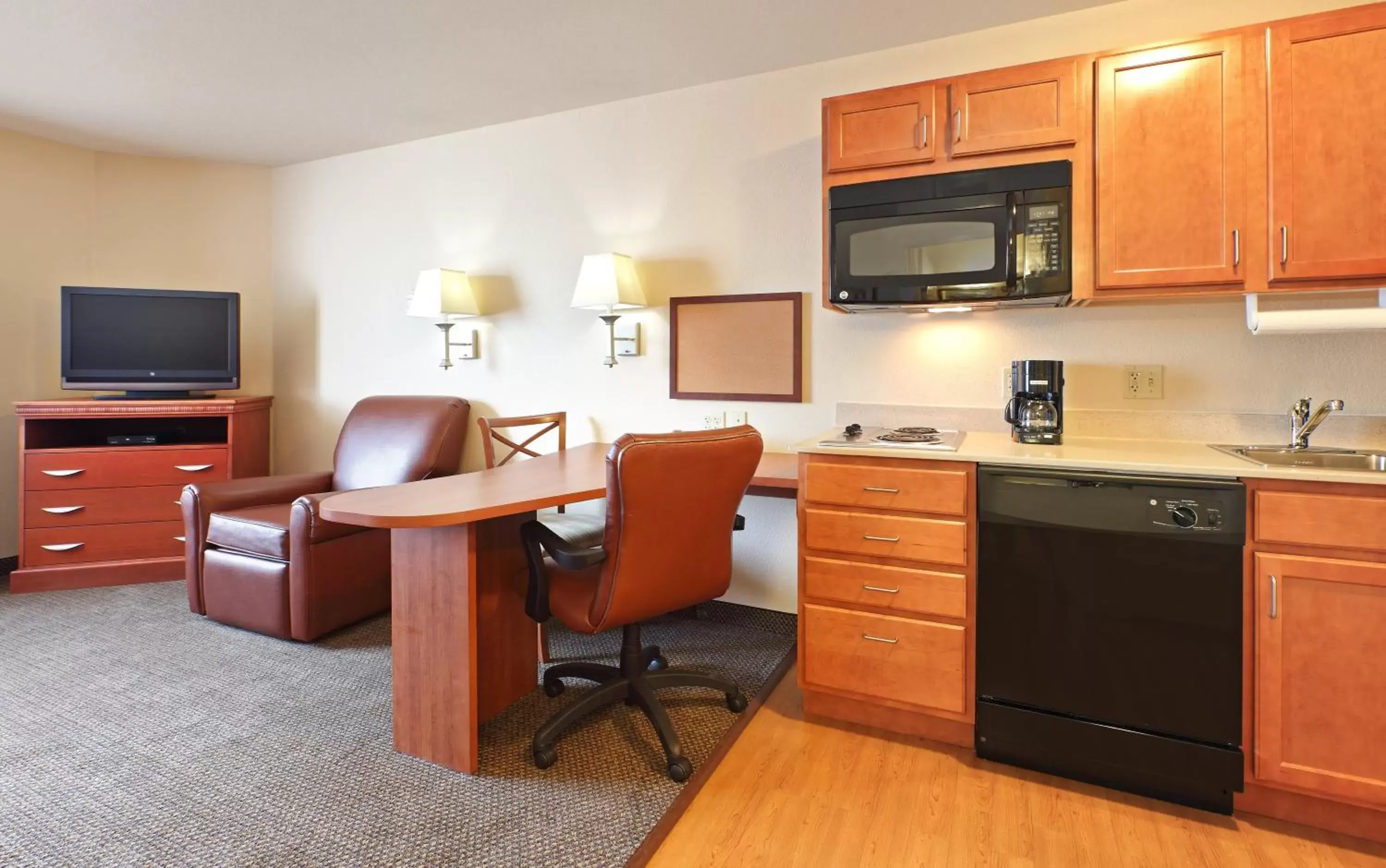 Bedroom, Kitchen/Kitchenette in Candlewood Suites Fayetteville, an IHG Hotel
