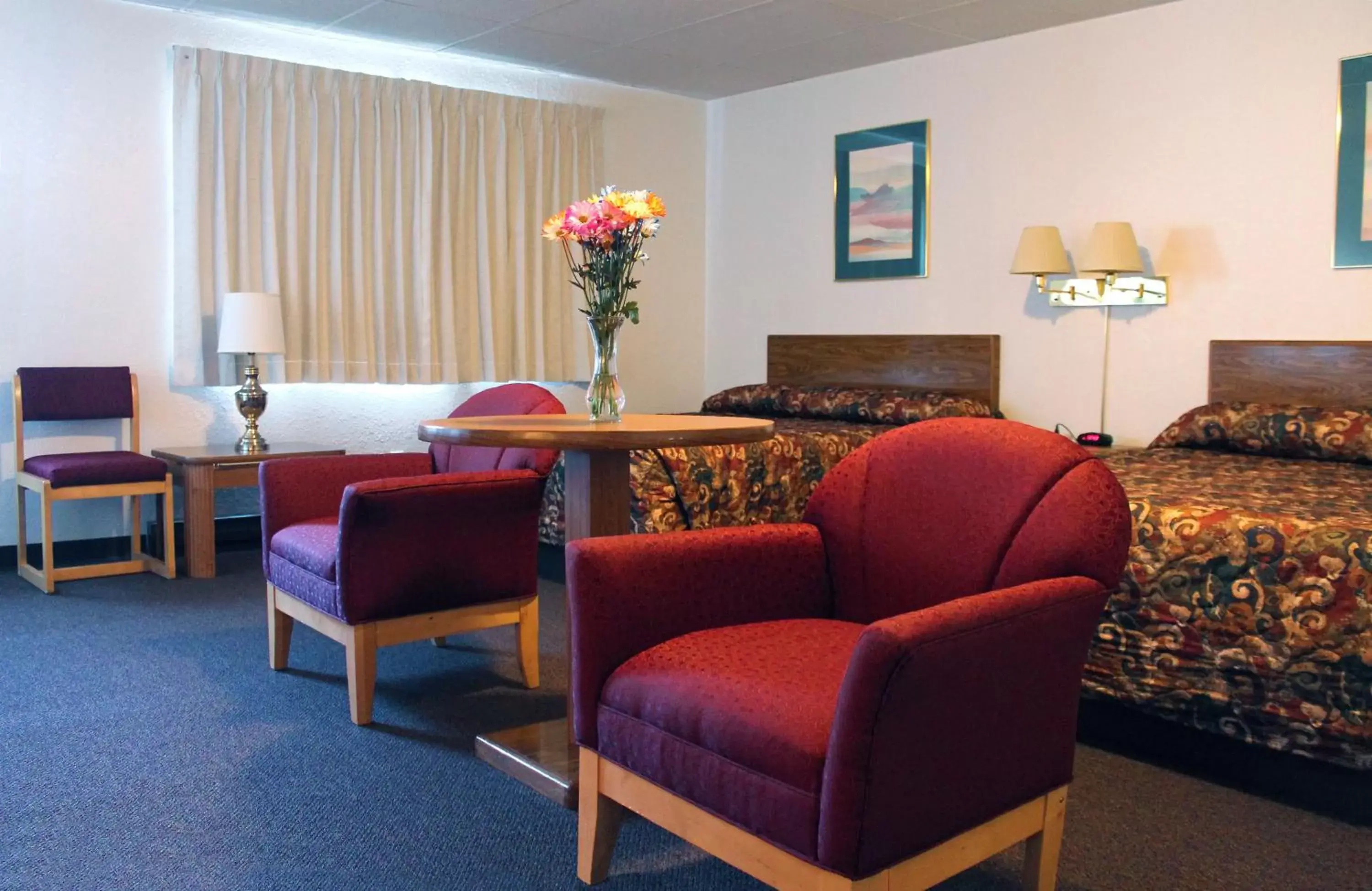 Bed, Seating Area in Budget Host Crestview Inn