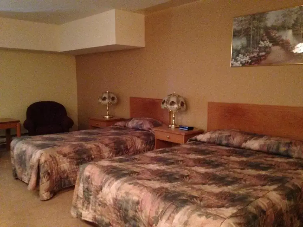 Bed in Western Budget Motel Peace River