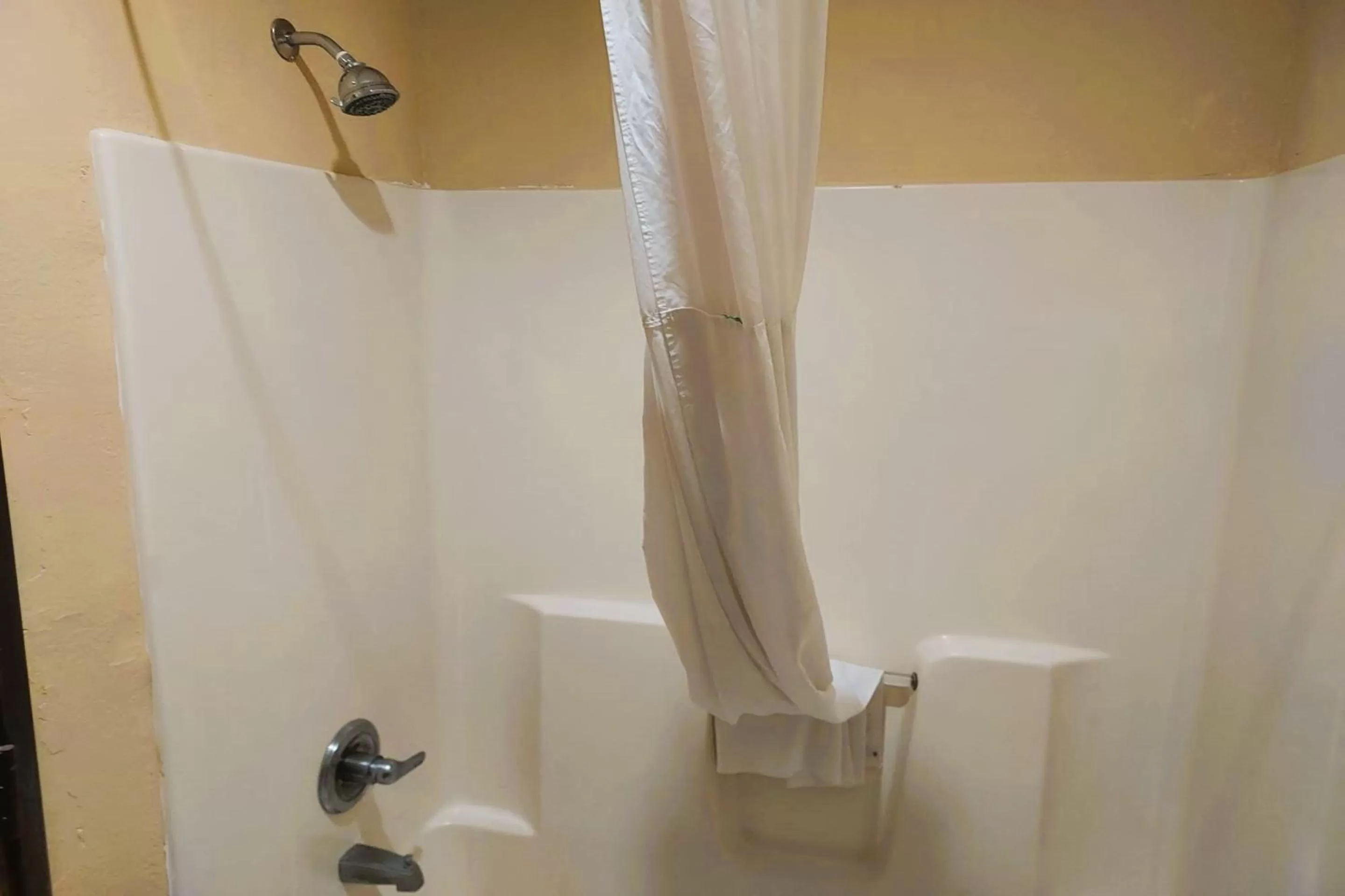 Bathroom in McPherson Inn By OYO, I-135