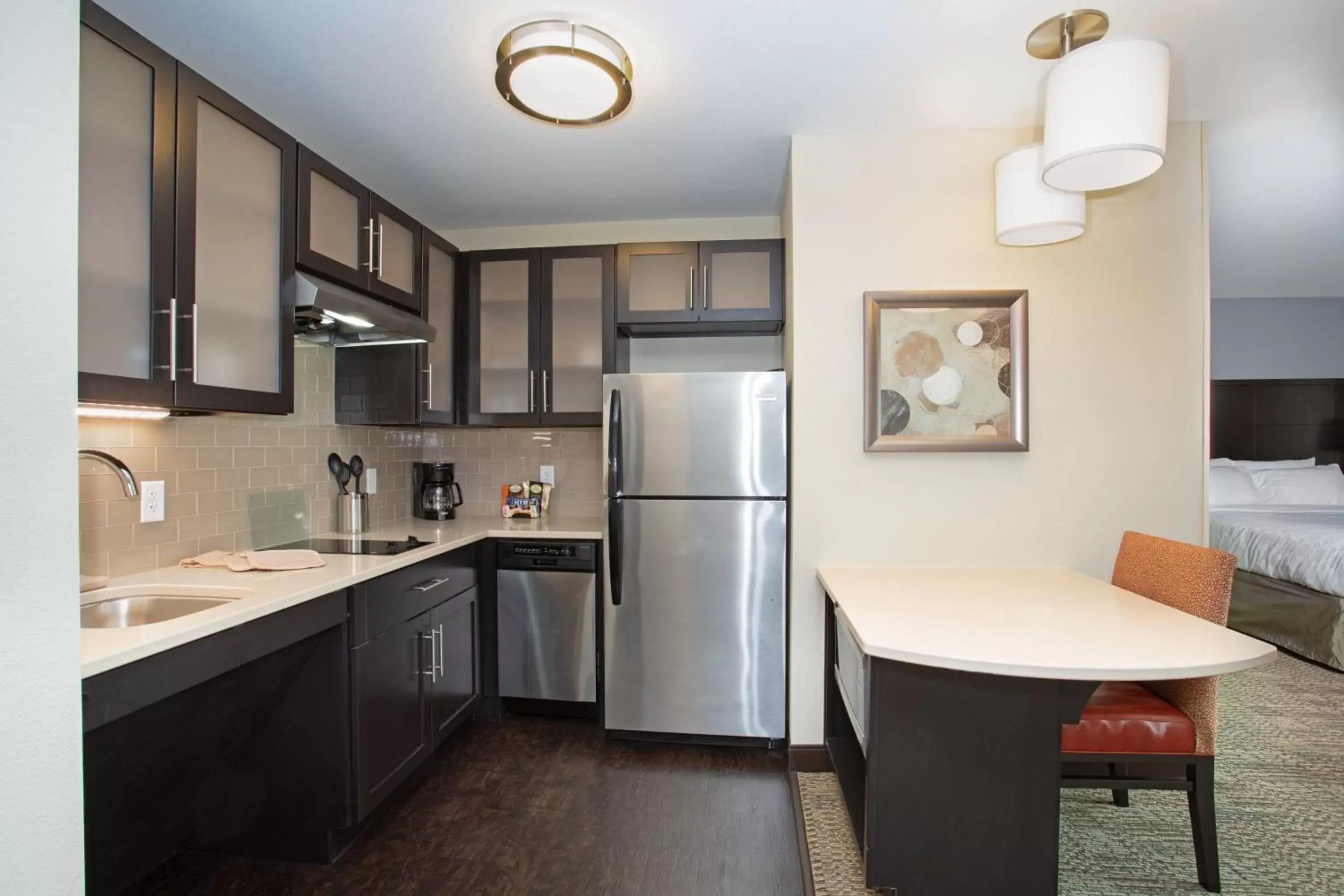 Bedroom, Kitchen/Kitchenette in Staybridge Suites Denver South - Highlands Ranch, an IHG Hotel