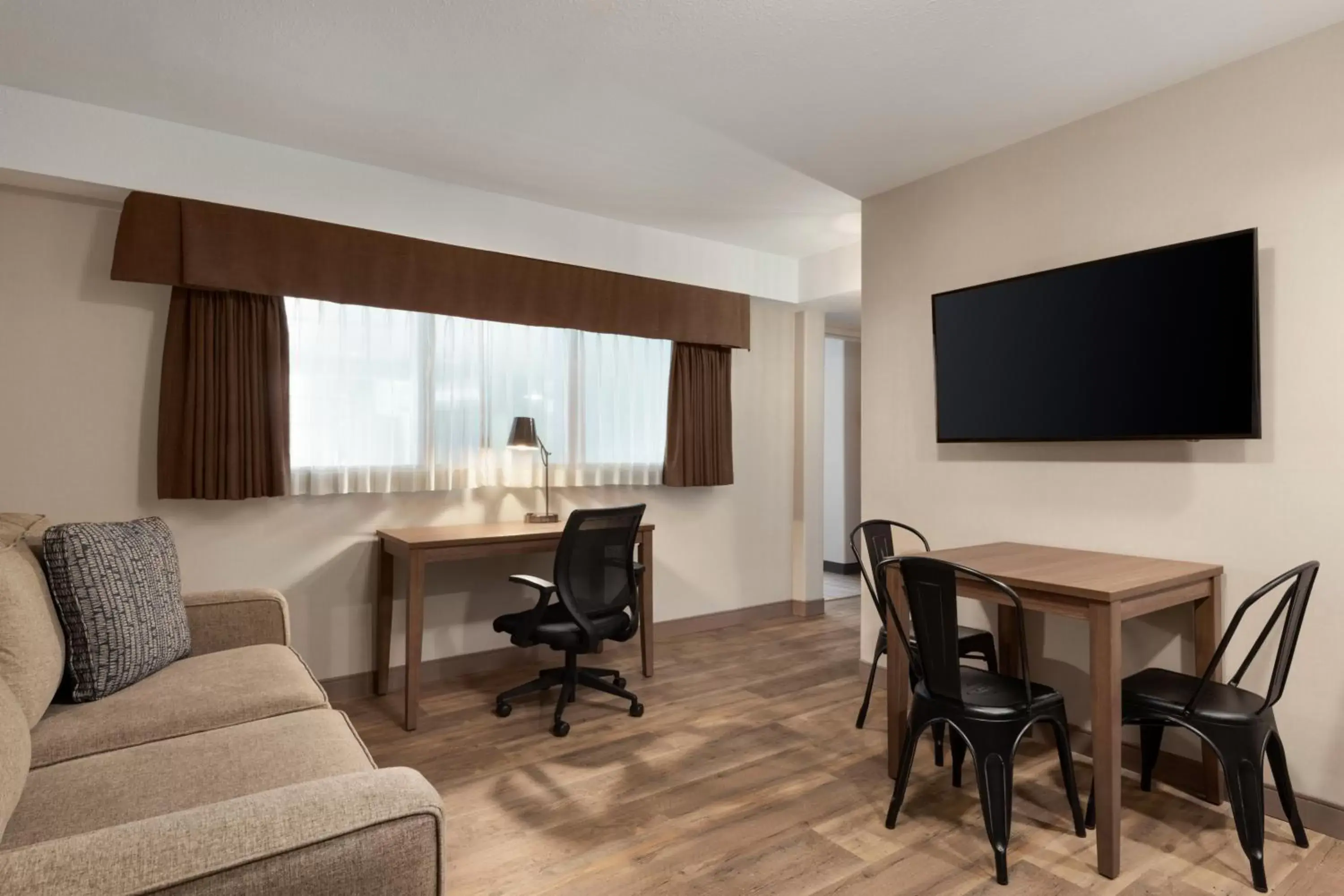 Seating area, TV/Entertainment Center in Ramada by Wyndham Airdrie Hotel & Suites