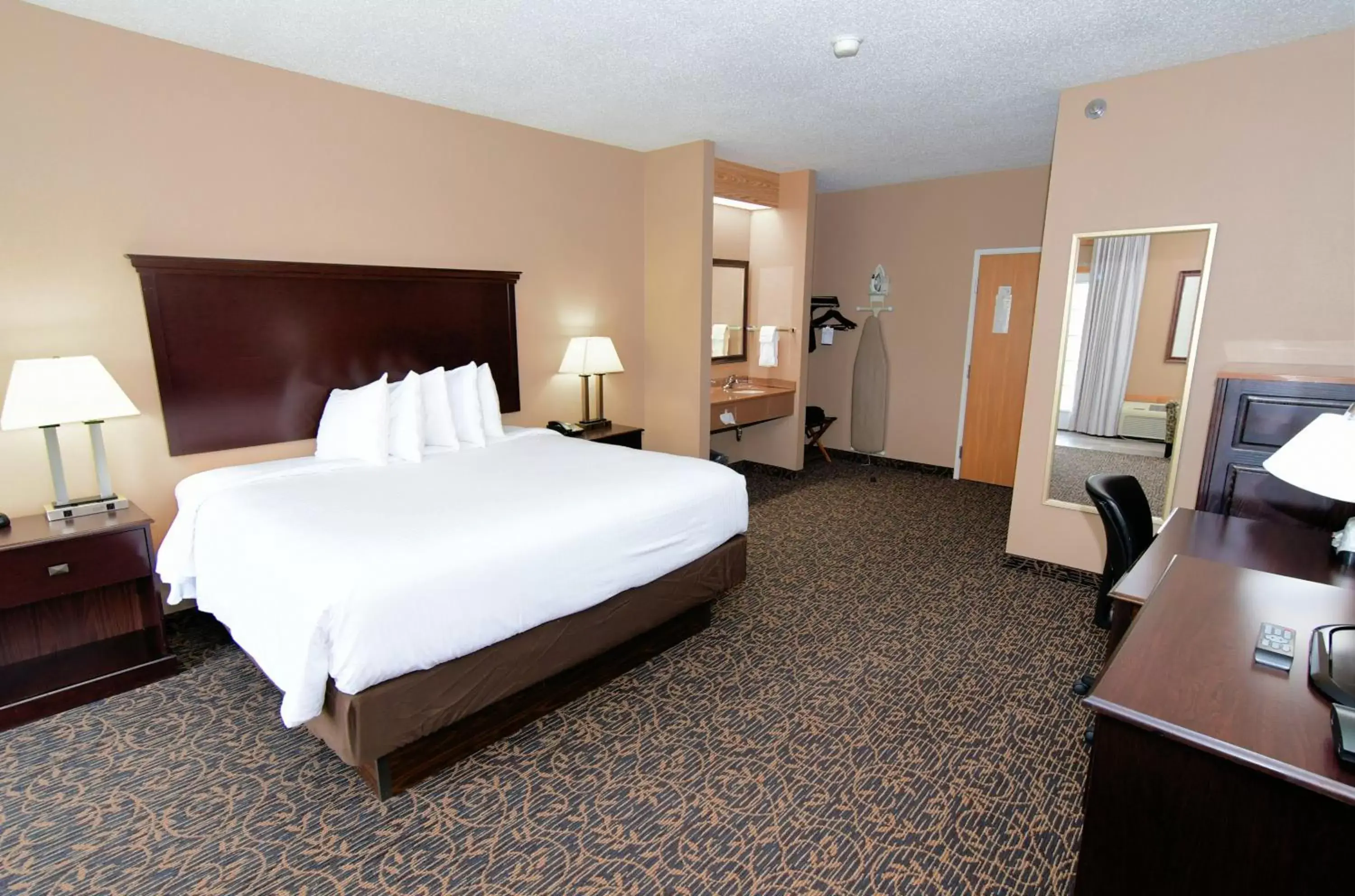 Bed in Cobblestone Inn & Suites - Denison | Majestic Hills