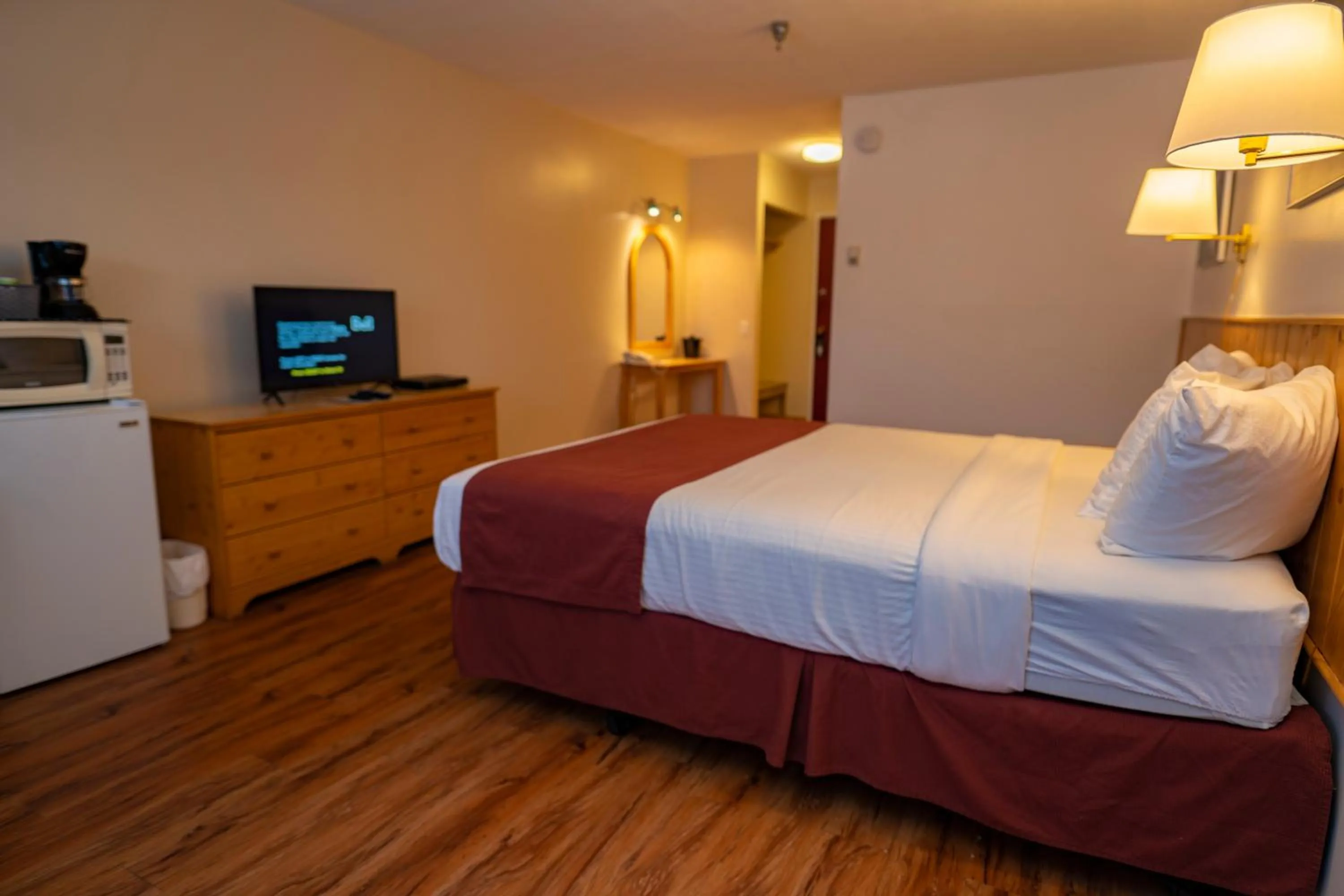Bed in Canadas Best Value Inn- Riverview Hotel