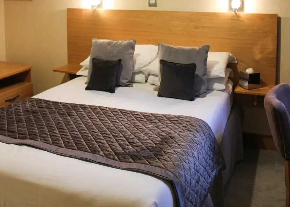 Bed in Station Hotel And Restaurant