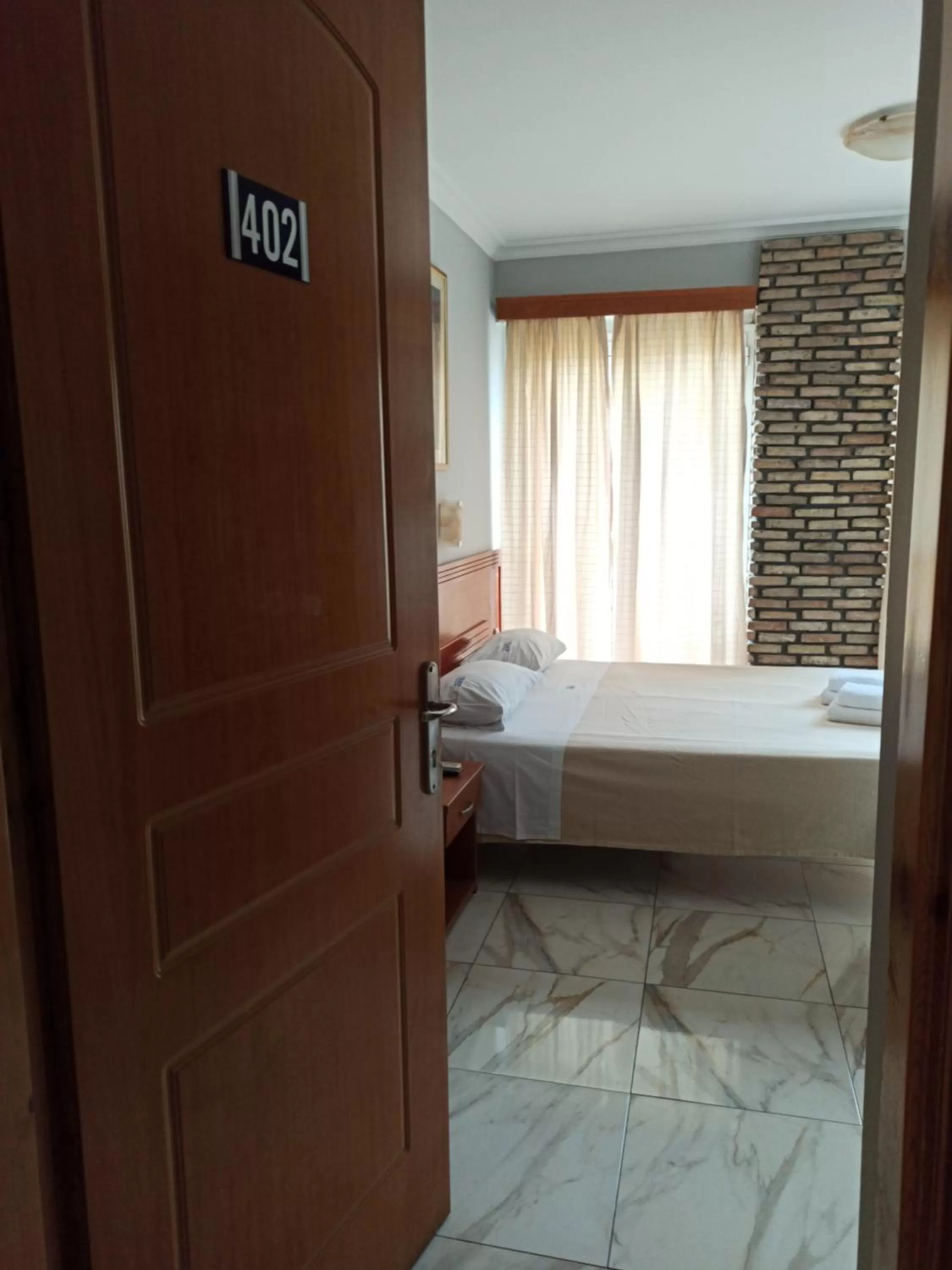 Bed in Piraeus Acropole Hotel