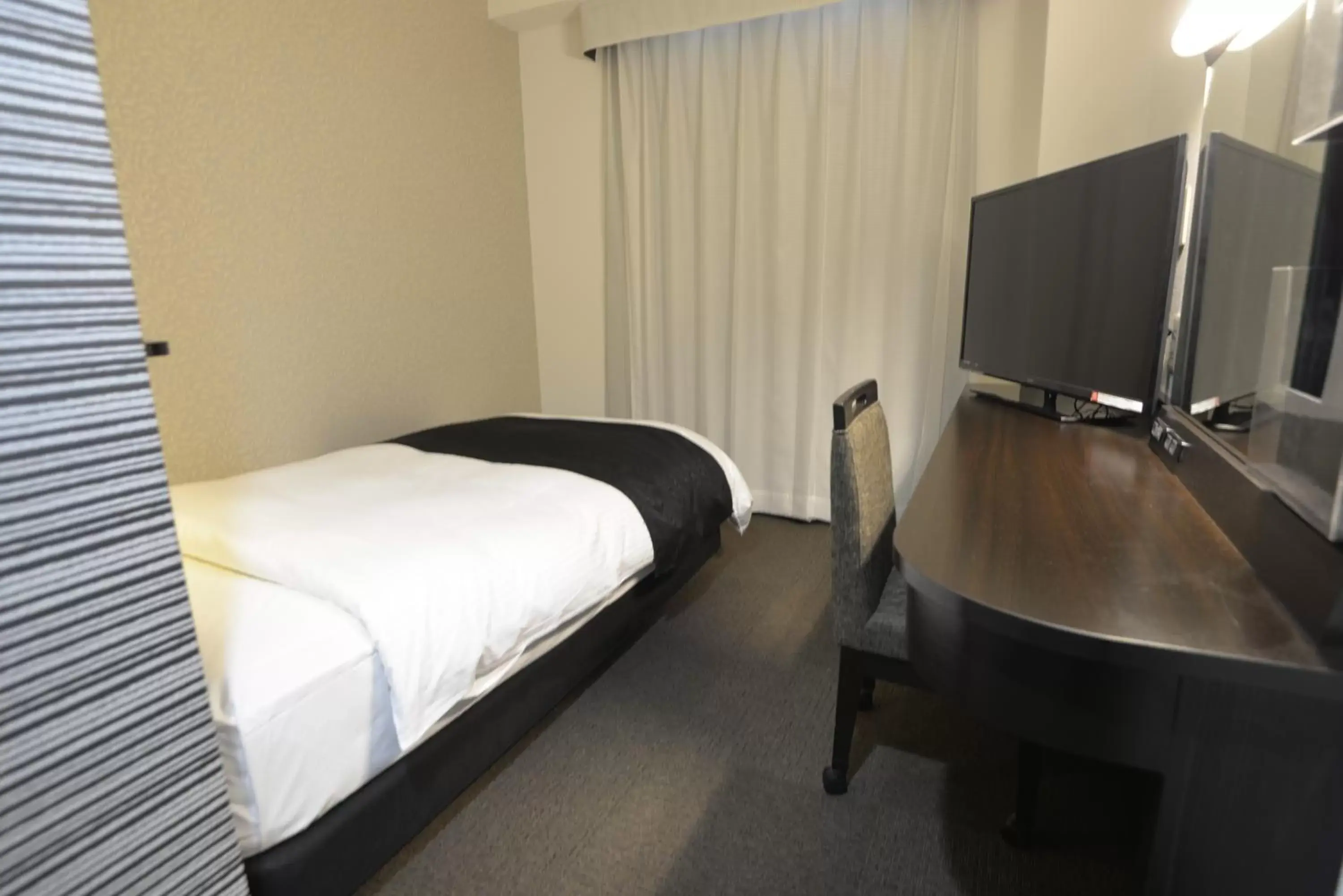 Photo of the whole room, Bed in APA Hotel Kagoshima Kokubu