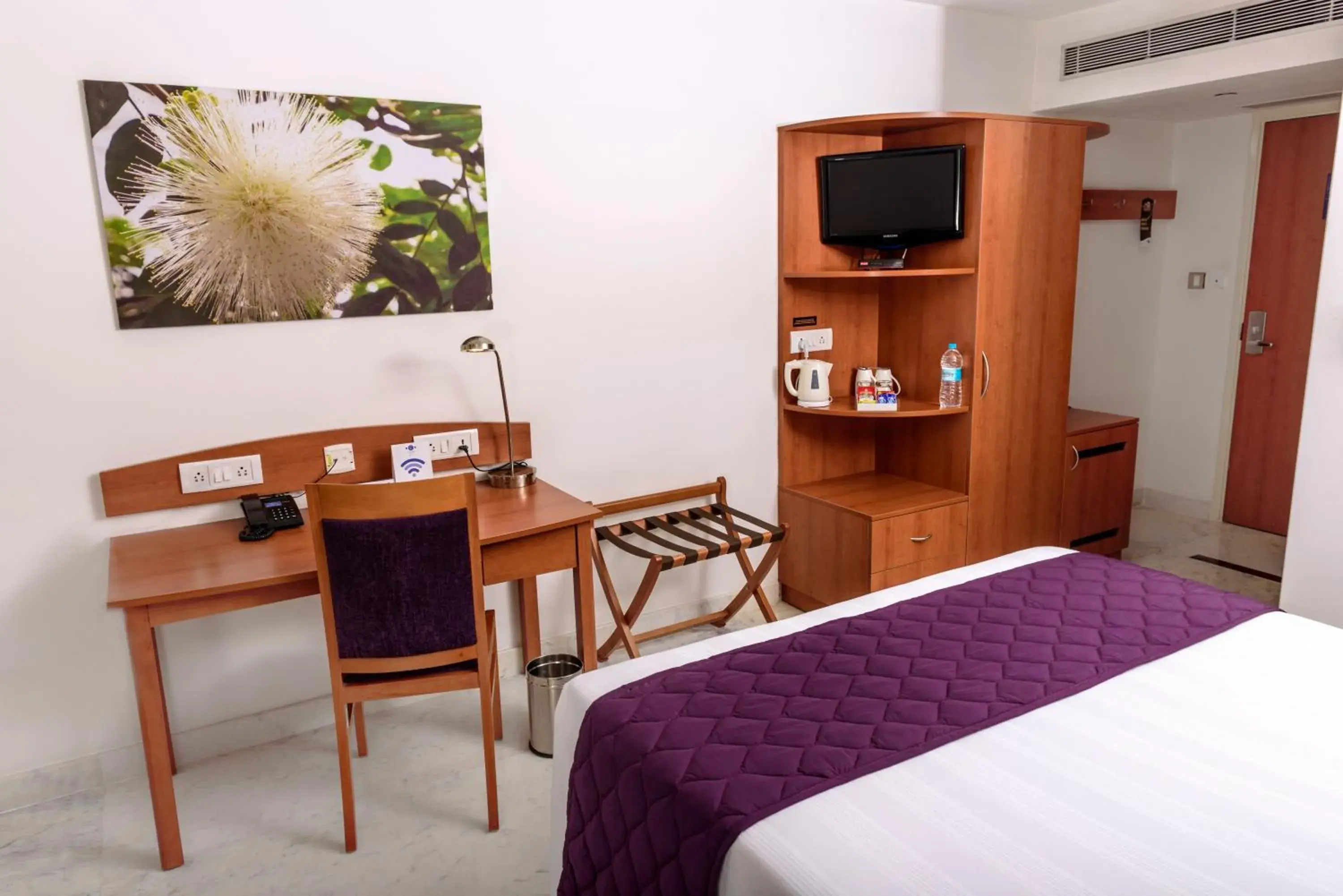 Bedroom, TV/Entertainment Center in Caspia Hotel New Delhi