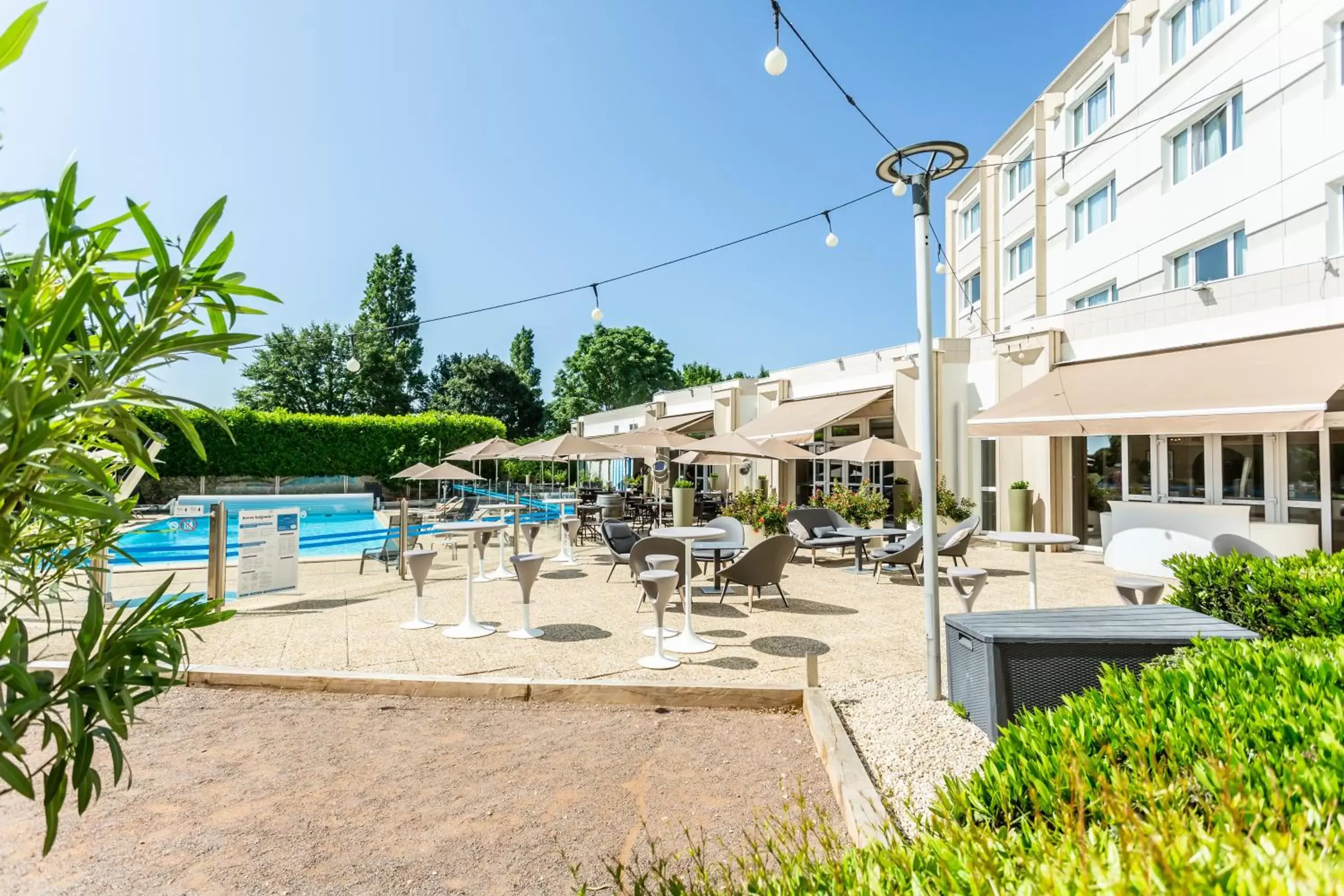 Patio, Swimming Pool in Novotel Bourges