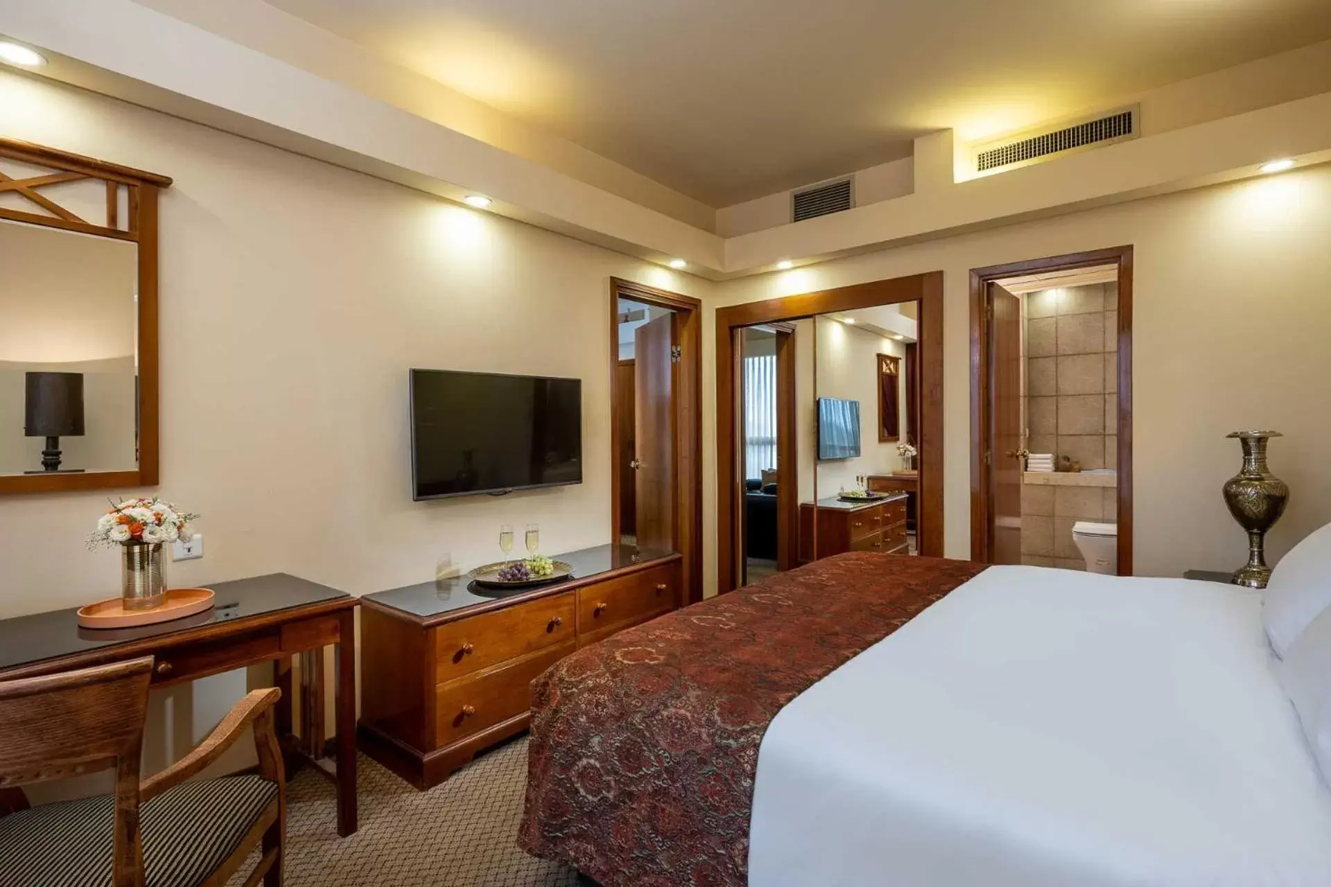 Bed, TV/Entertainment Center in Olive Tree Hotel