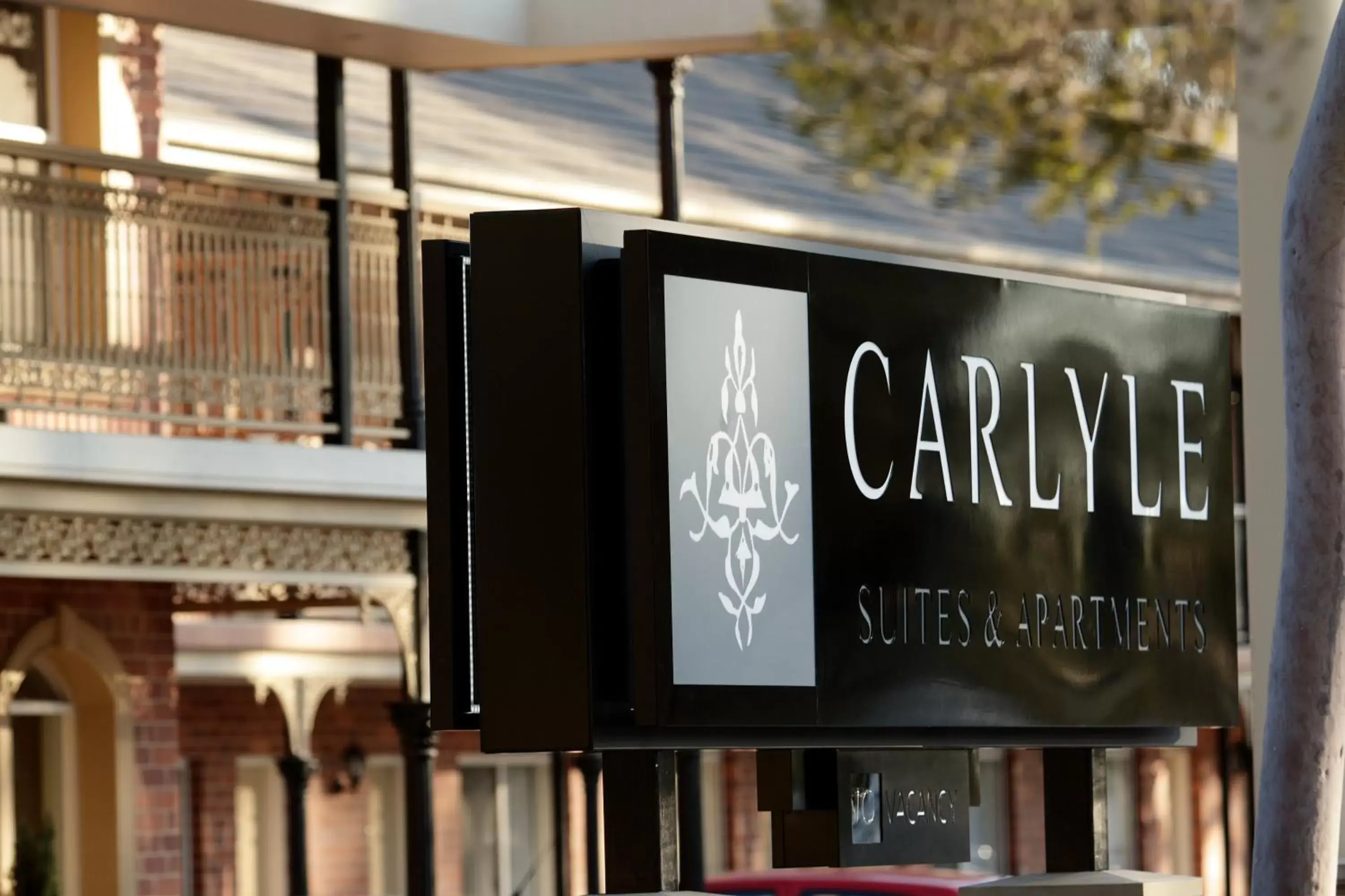 Facade/entrance, Property Logo/Sign in Carlyle Suites & Apartments
