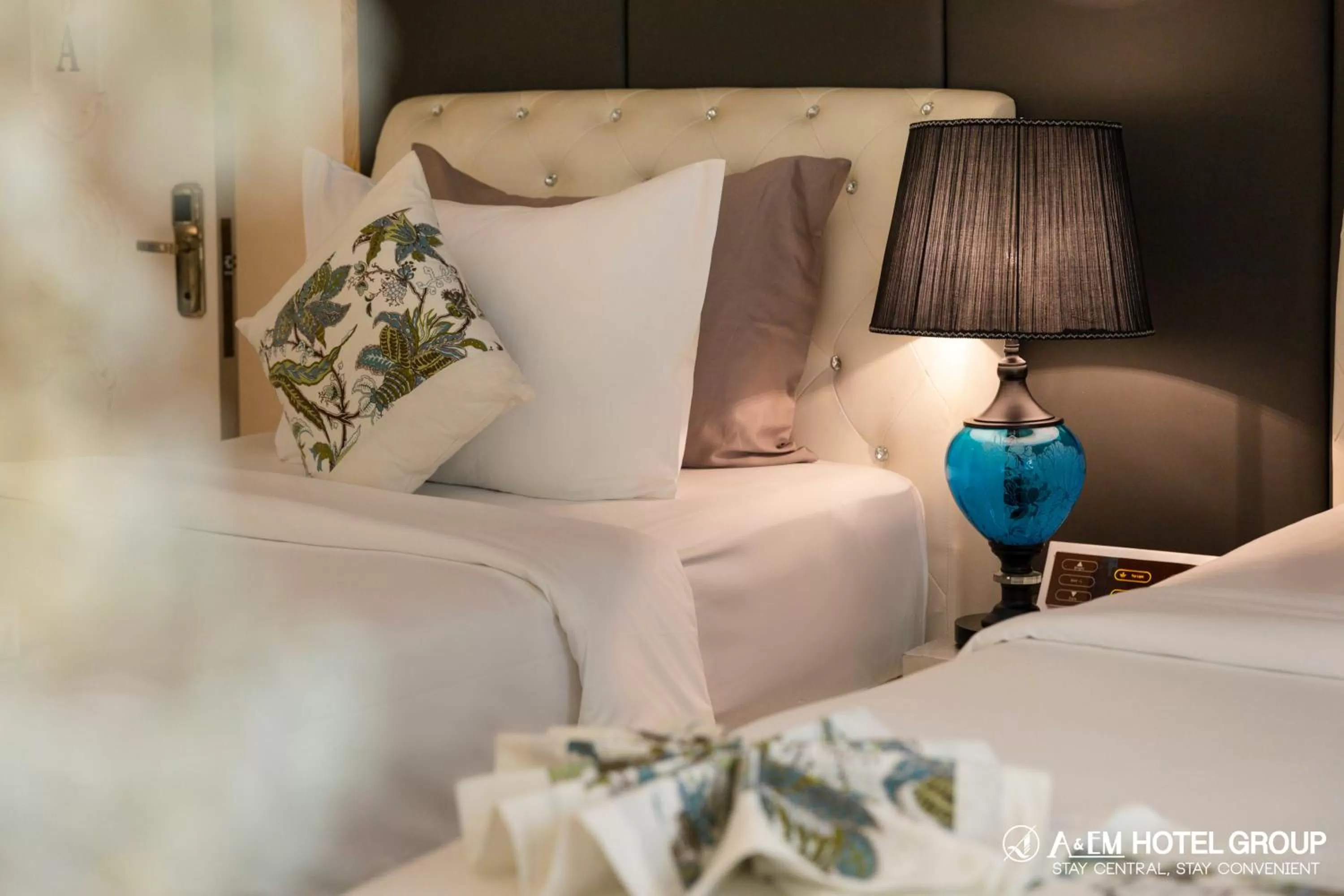 Bed in A&EM Saigon Hotel