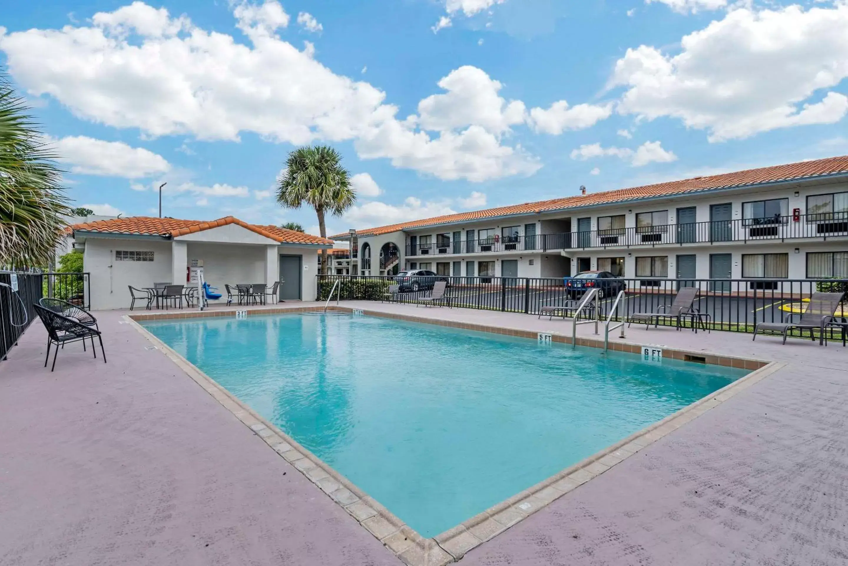 Swimming Pool in Days Inn & Suites by Wyndham Orlando East UCF Area