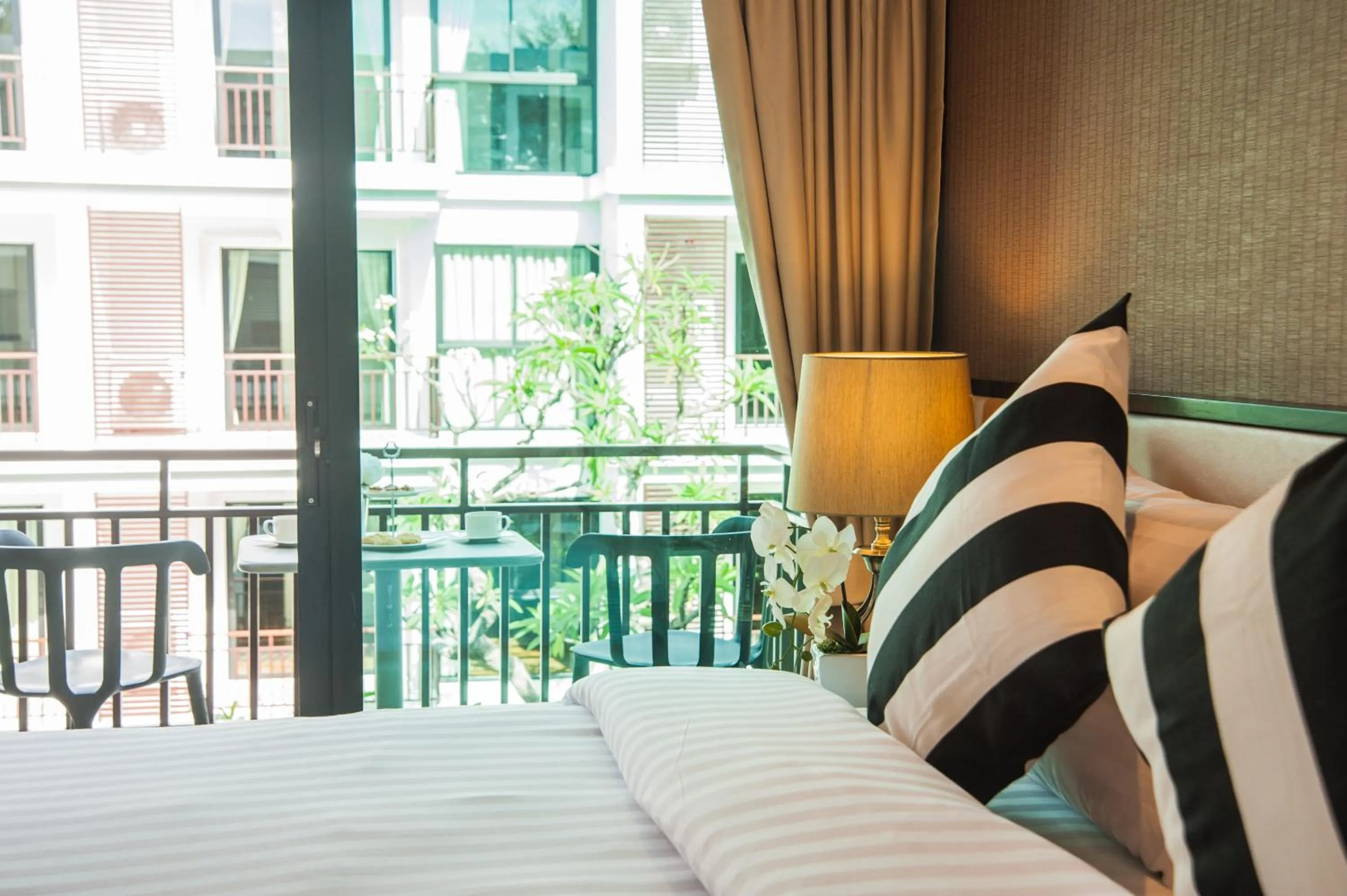 Balcony/Terrace, Bed in The Title KR Beach Condotel Rawai Beach