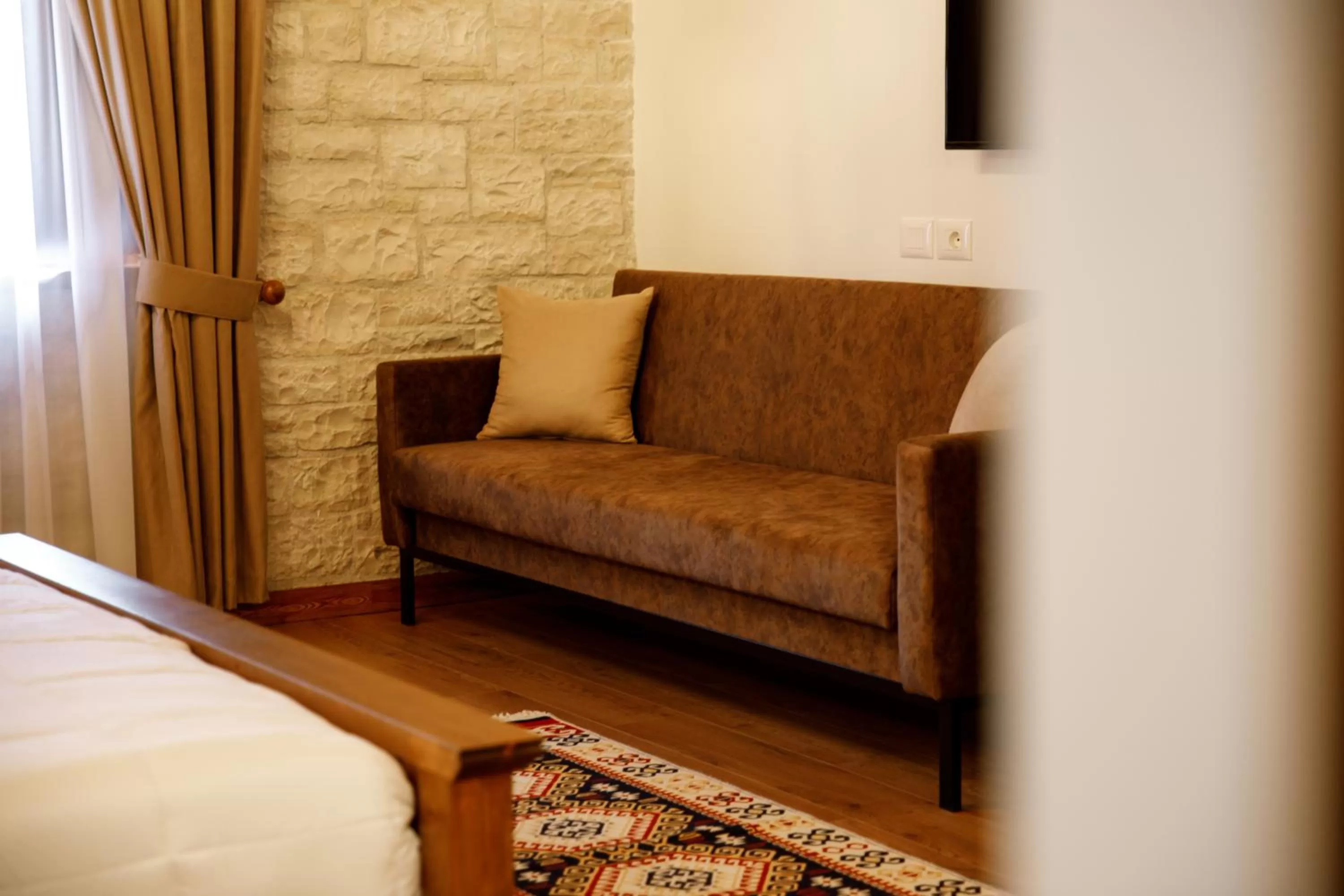 Seating area, Bed in Rose Garden Hotel