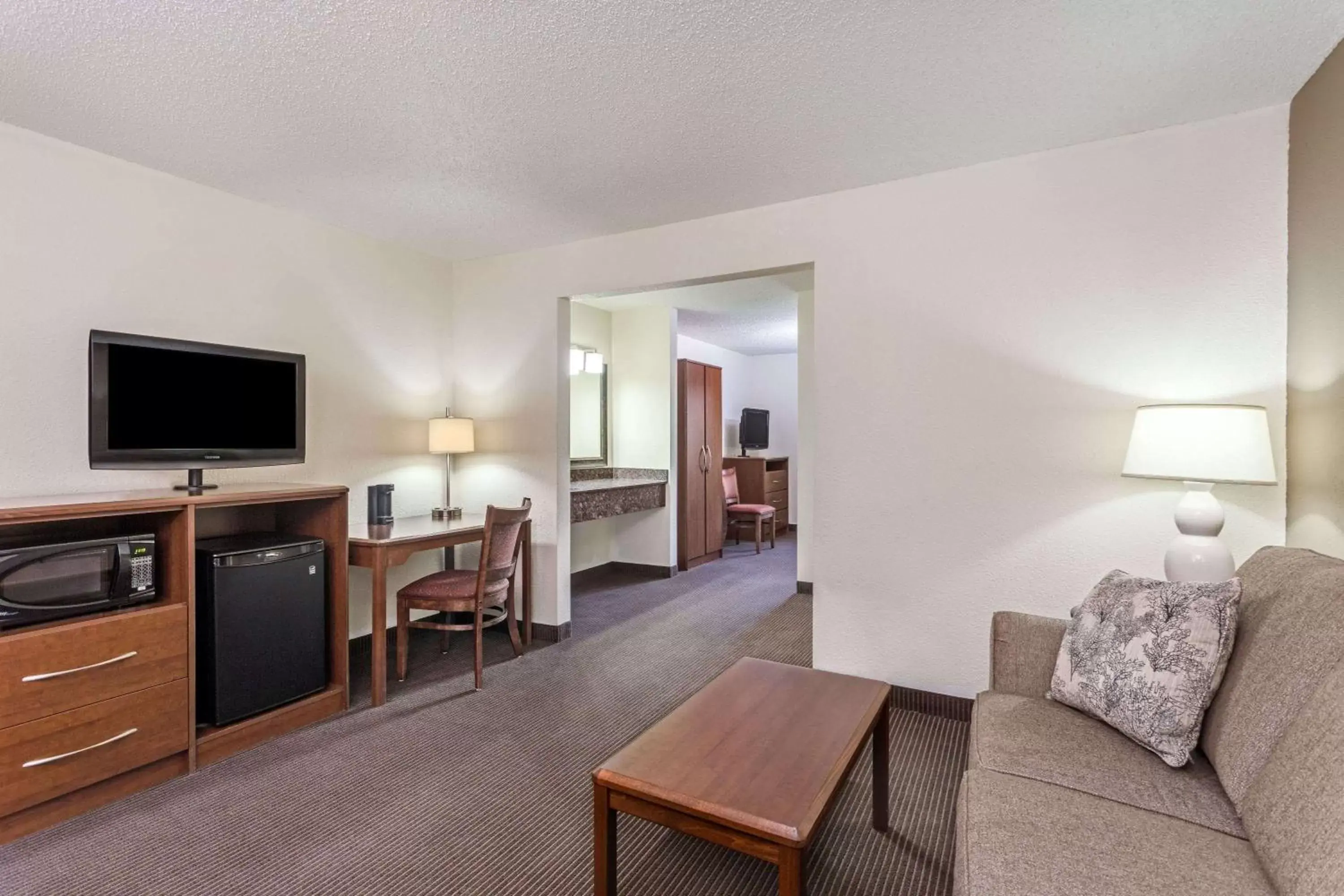 Photo of the whole room, Seating Area in AmericInn by Wyndham Monroe