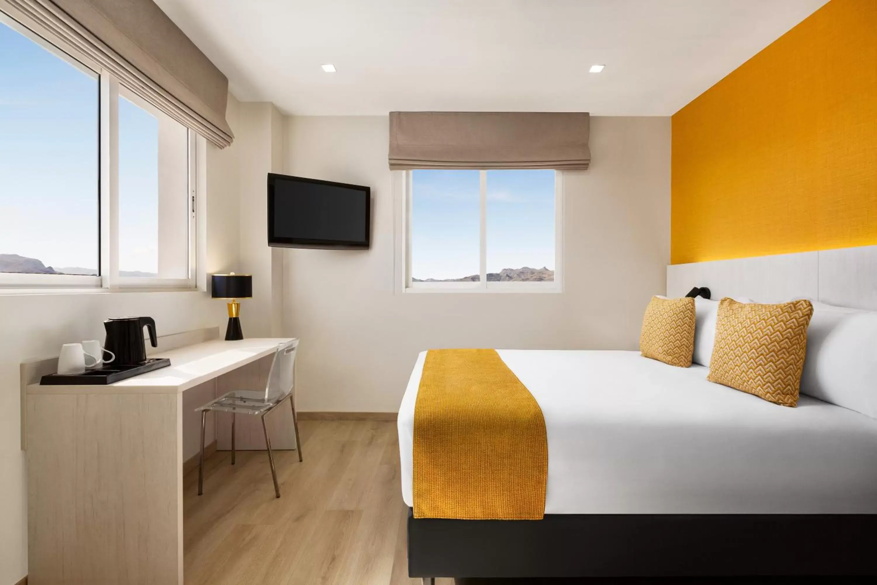 Bed, TV/Entertainment Center in Ramada Resort by Wyndham Puerto de Mazarron