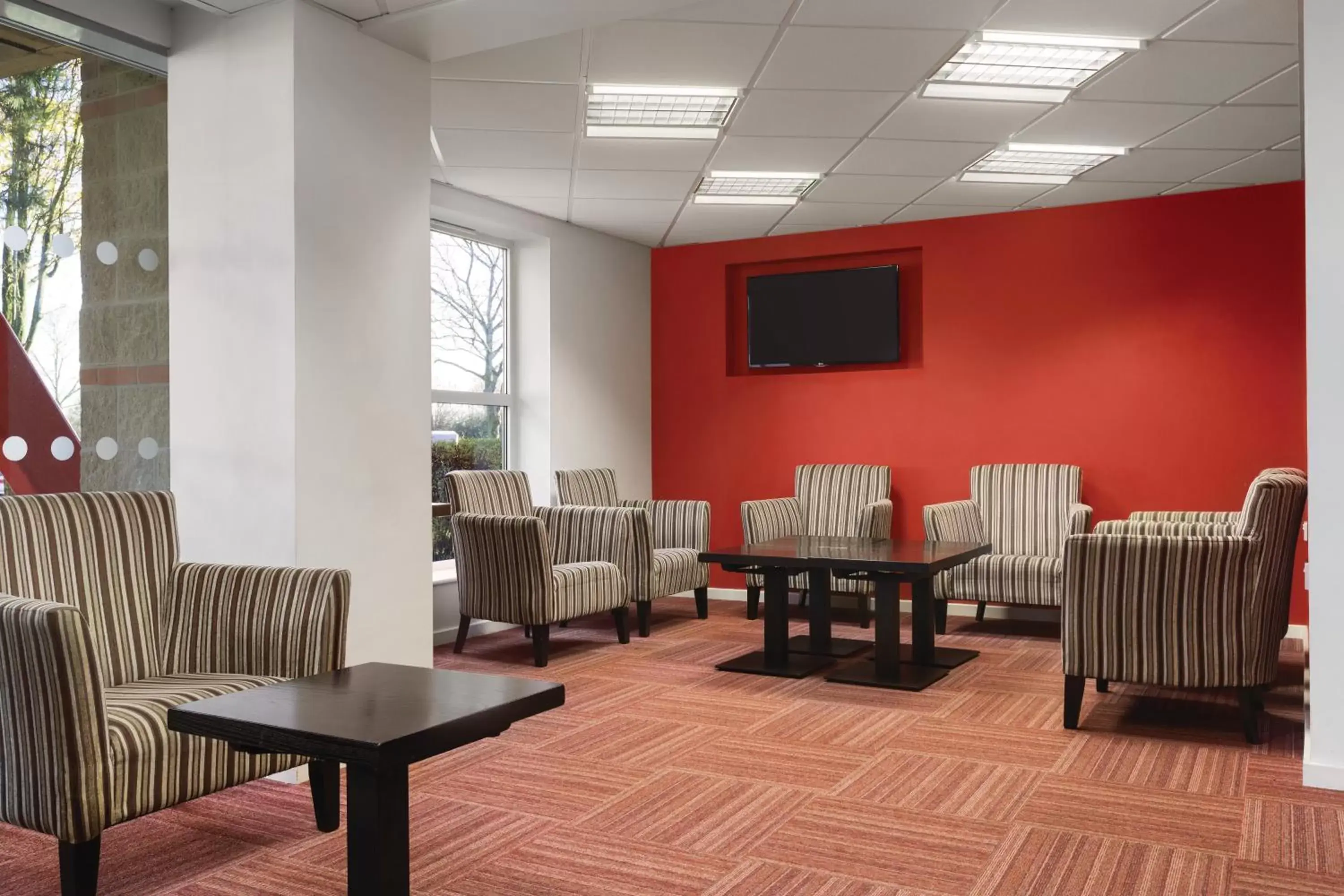 Communal lounge/ TV room in Ramada London Stansted Airport