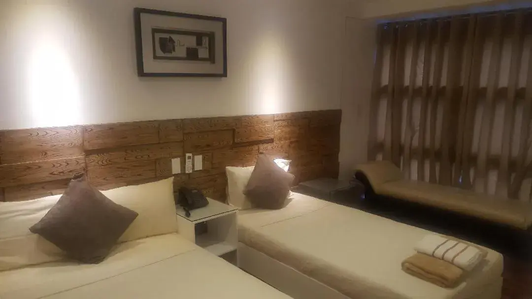 Bed in Gervasia Hotel Makati
