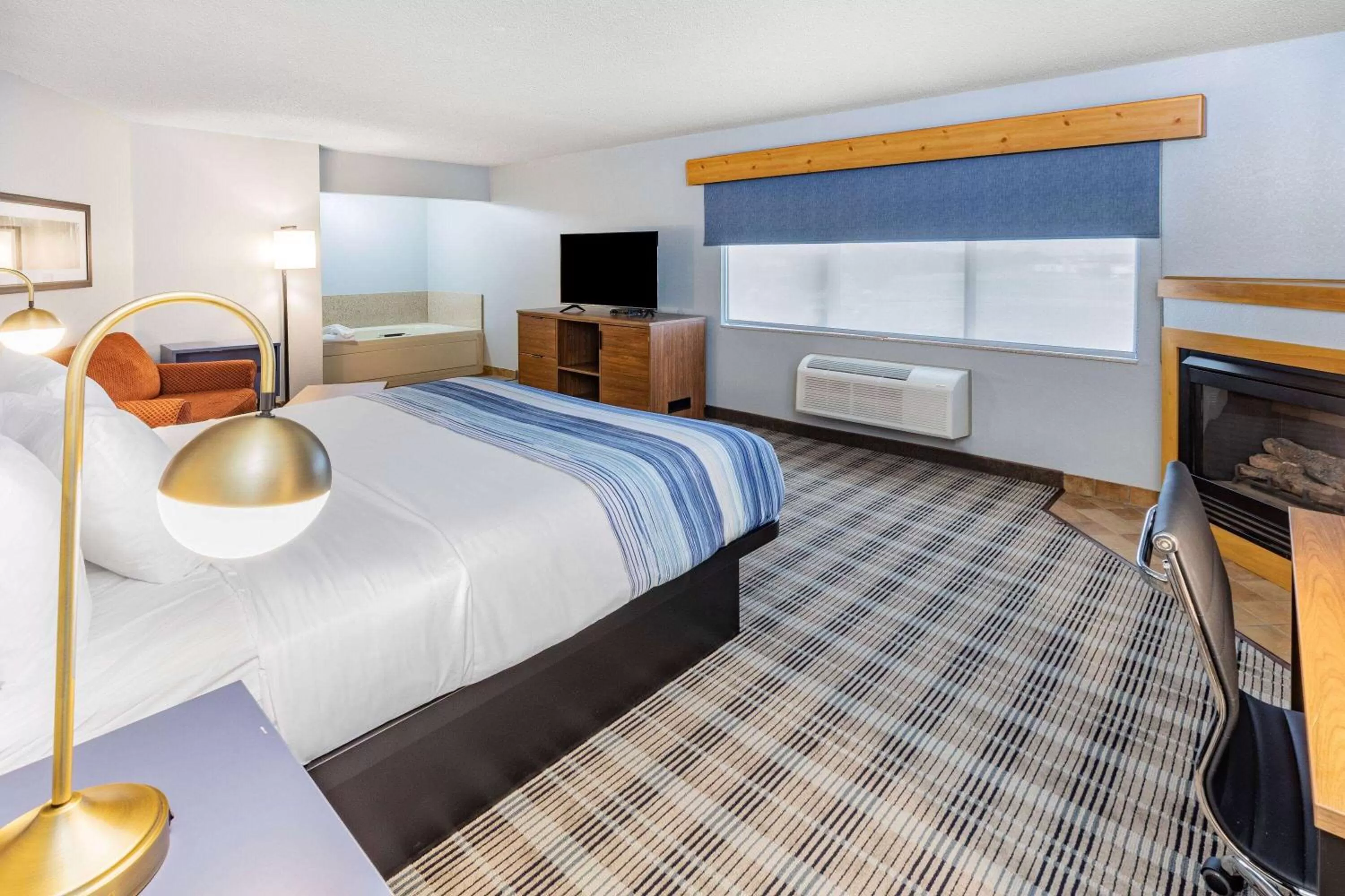 Bed in AmericInn by Wyndham Sayre