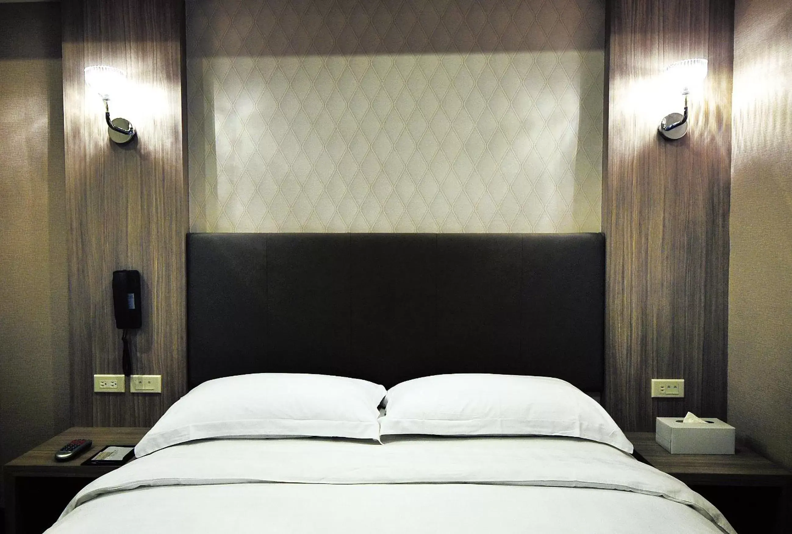 Bed in The Riverside Hotel International