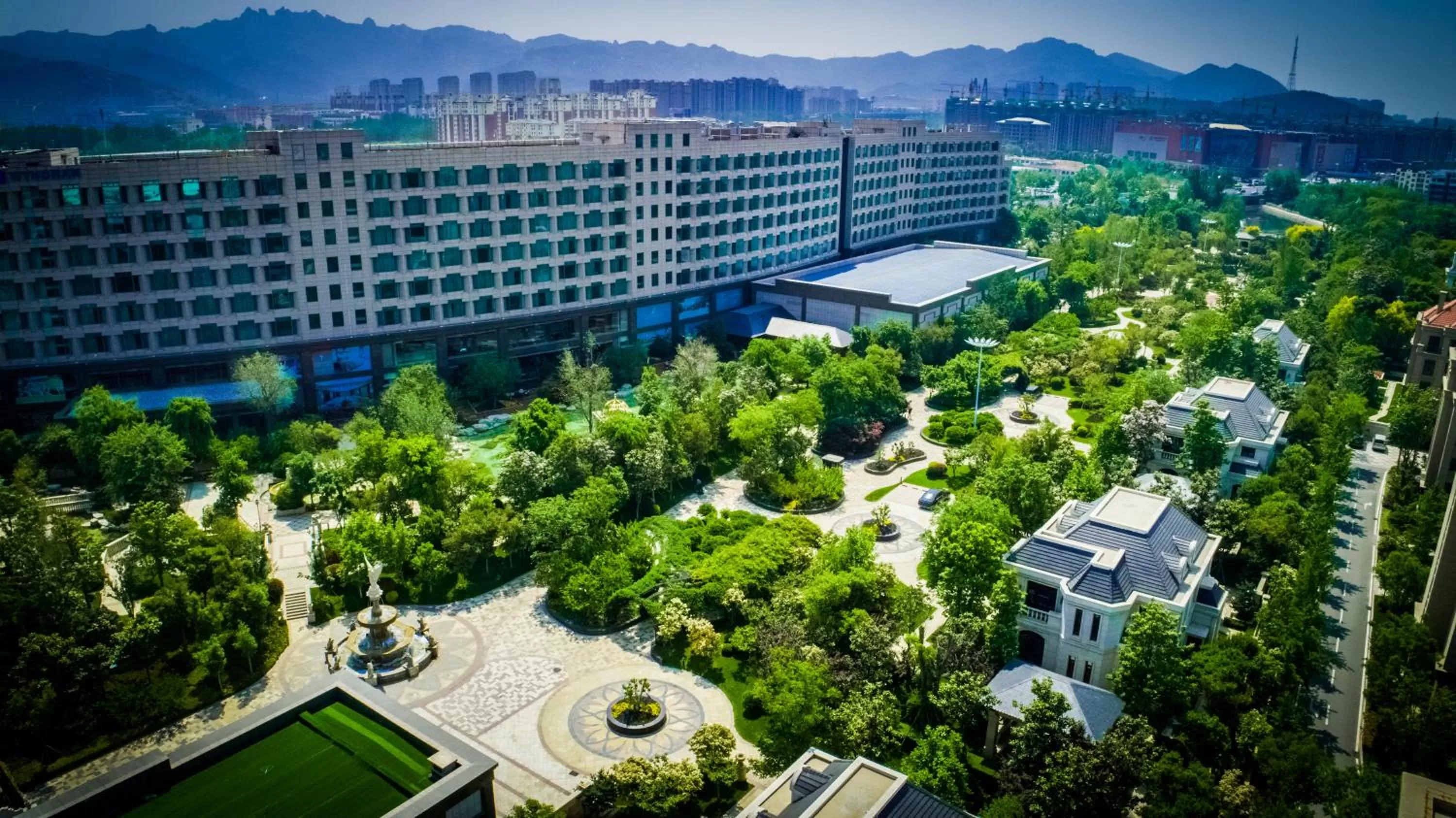 Property building in Wyndham Qingdao l Free Fixed-Time Shuttle Service Between Hotel and Airport & North Railway Station l Outdoor Children's Amusement Park l 1-Hour Play Snooker or Table Tennis