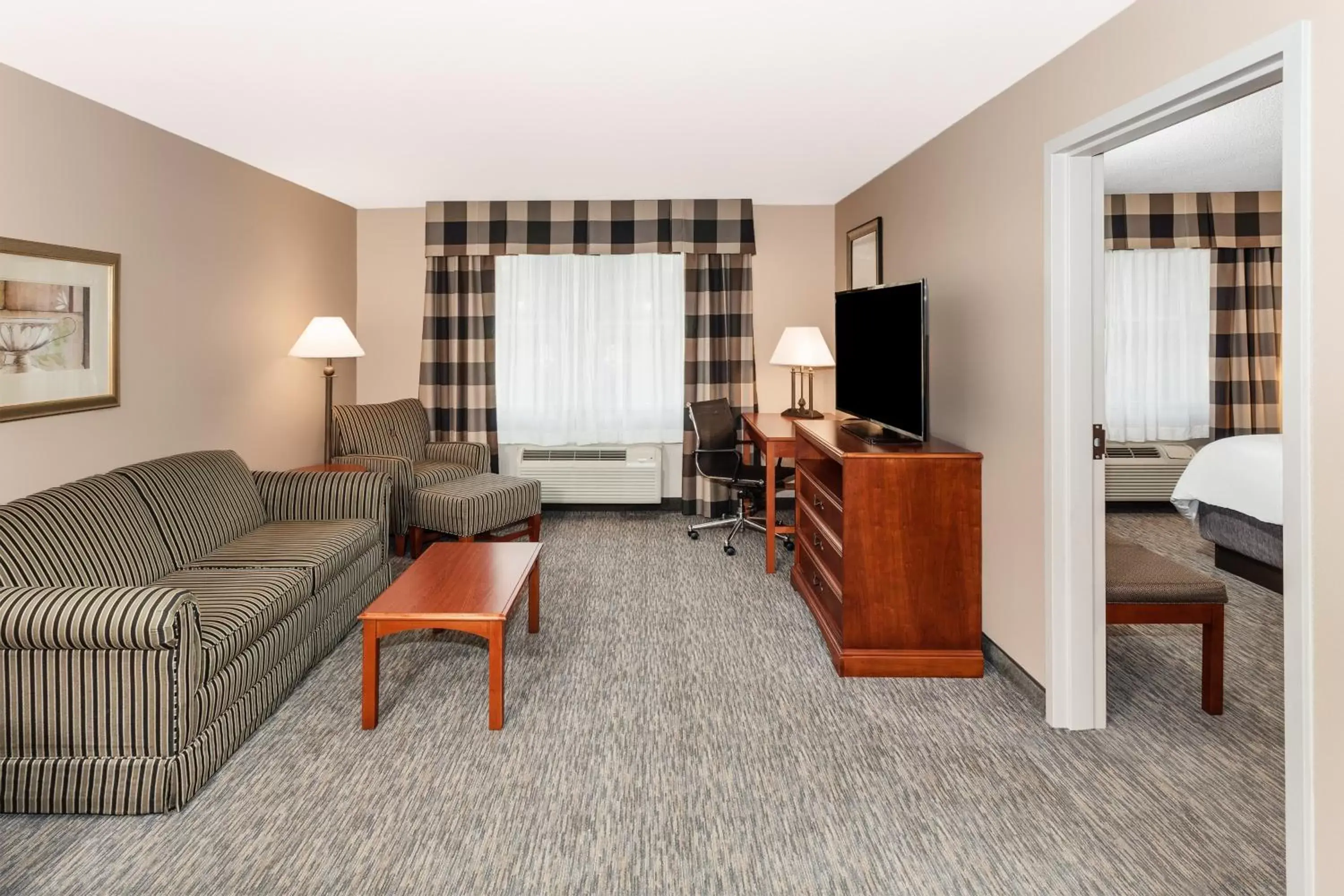 Bedroom, Seating Area in Holiday Inn Express Hotel & Suites Hampton South-Seabrook, an IHG Hotel