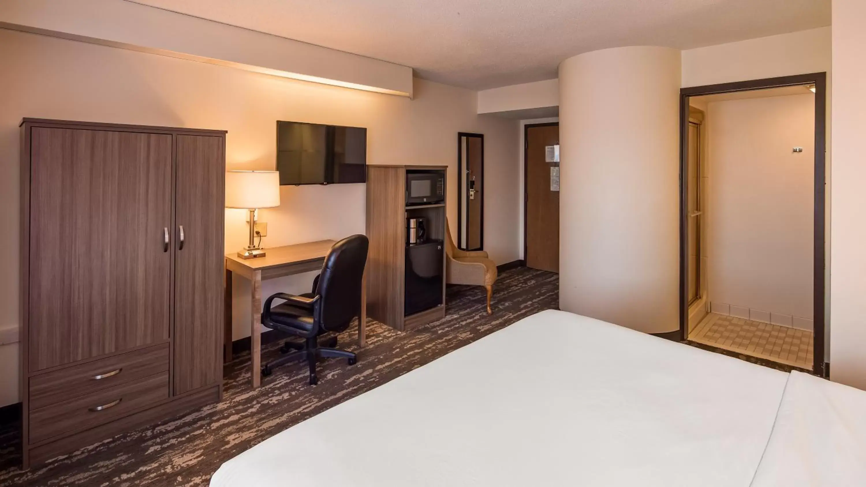 Bed in Charlevoix Inn & Suites SureStay Collection by Best Western