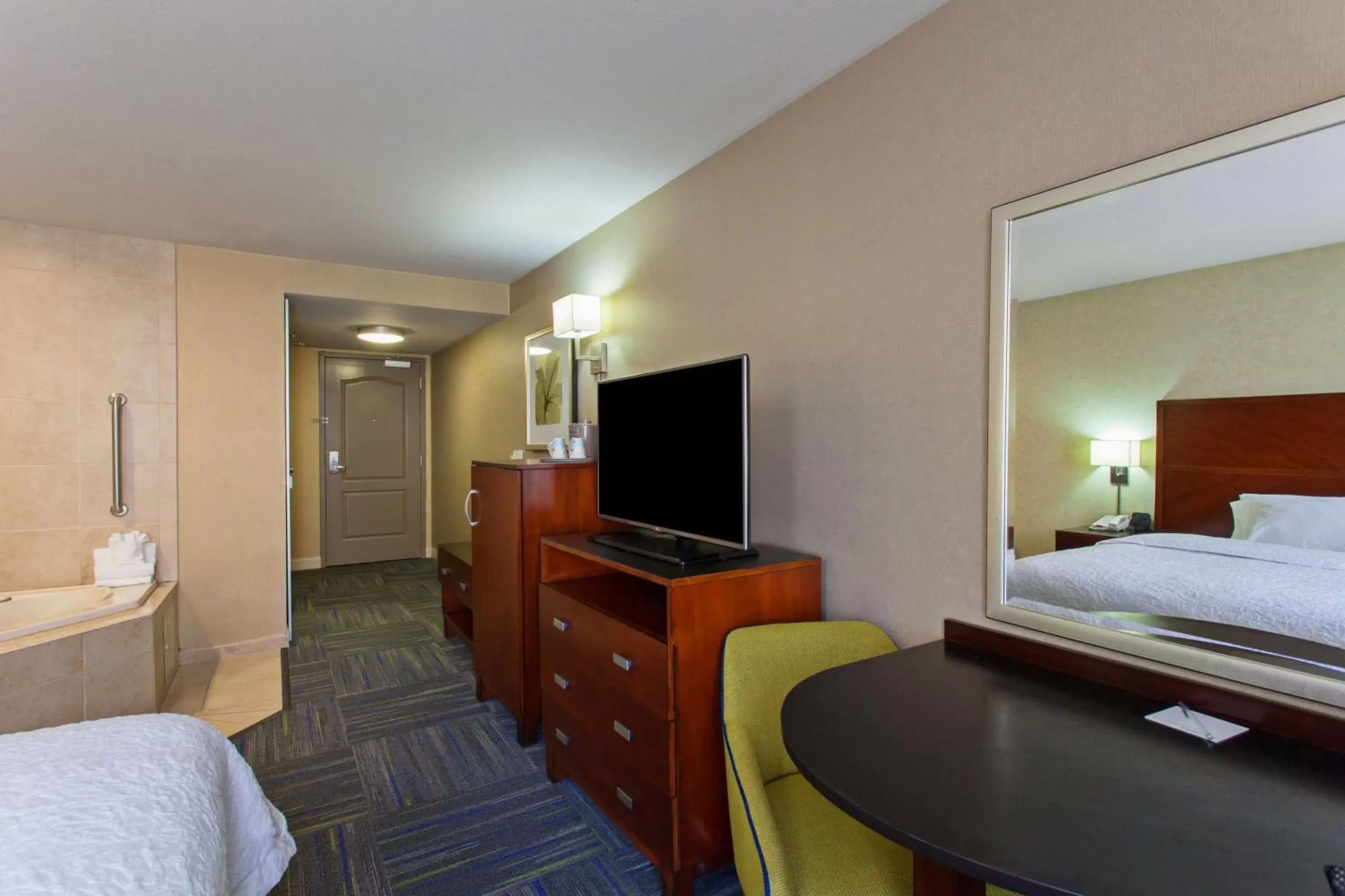 Bed, TV/Entertainment Center in Hampton Inn and Suites Merced