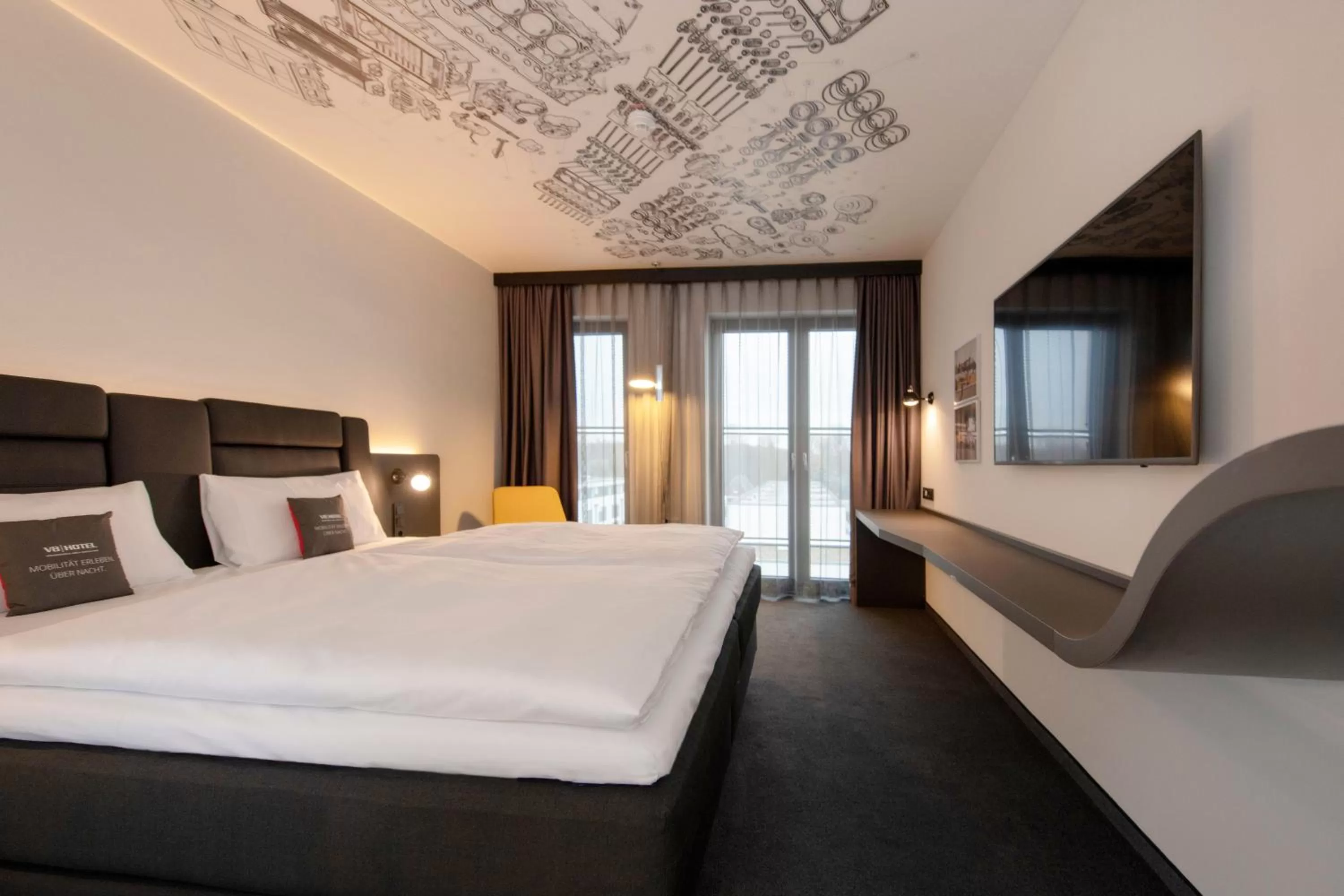 Photo of the whole room, Bed in V8 Hotel Köln at MOTORWORLD