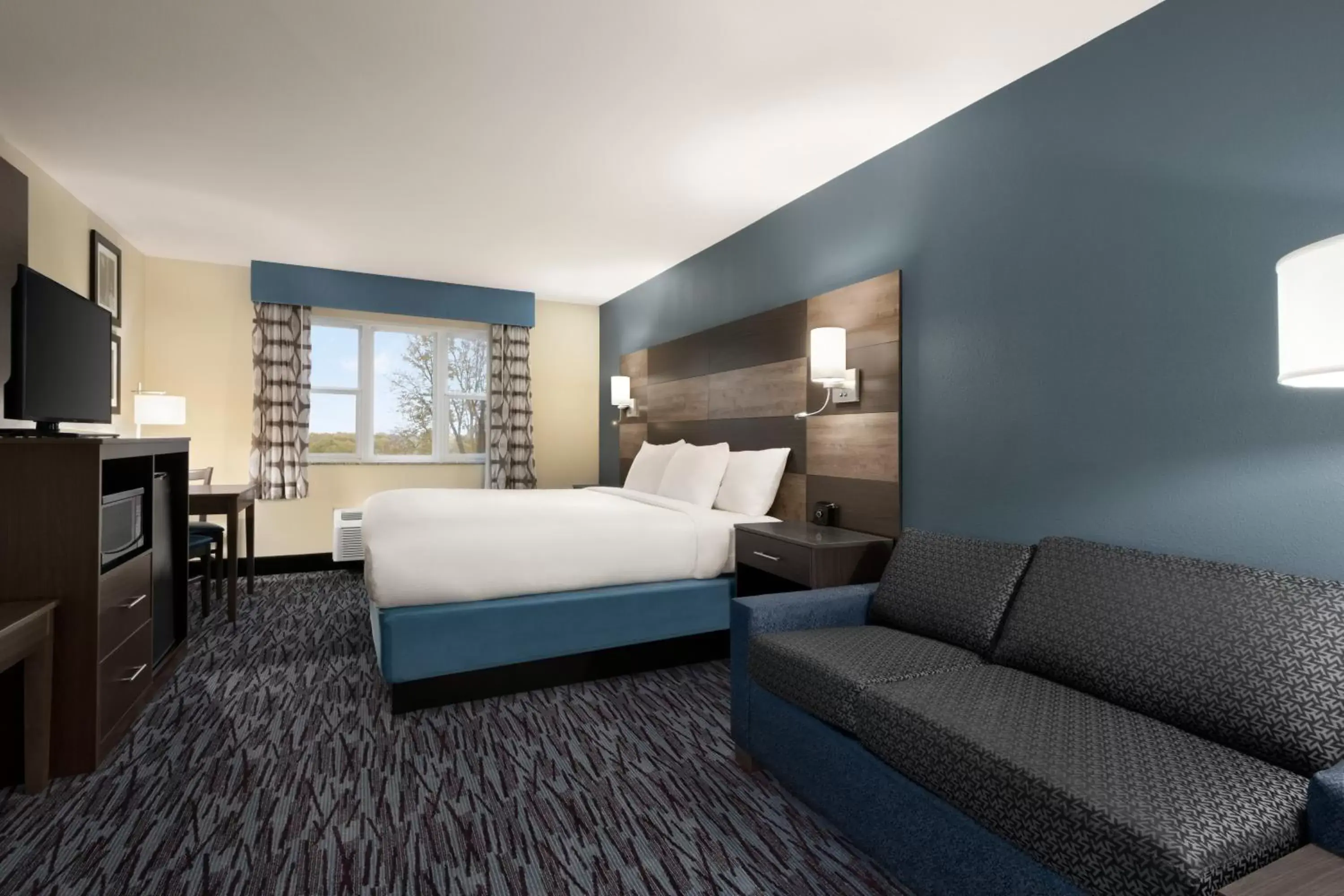 Living room, Bed in AmericInn by Wyndham Dodgeville