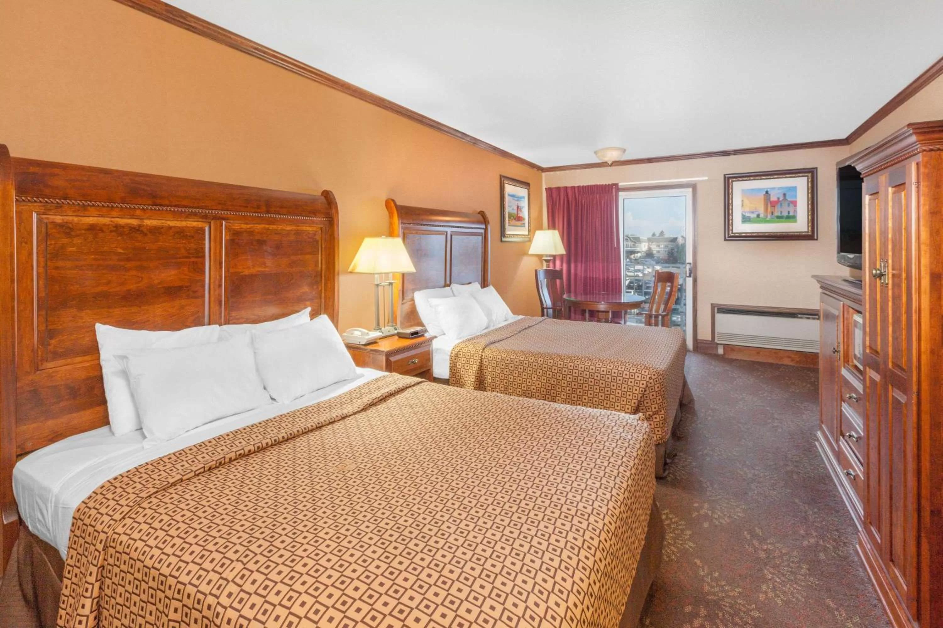 Photo of the whole room, Bed in Ramada by Wyndham Mackinaw City Waterfront